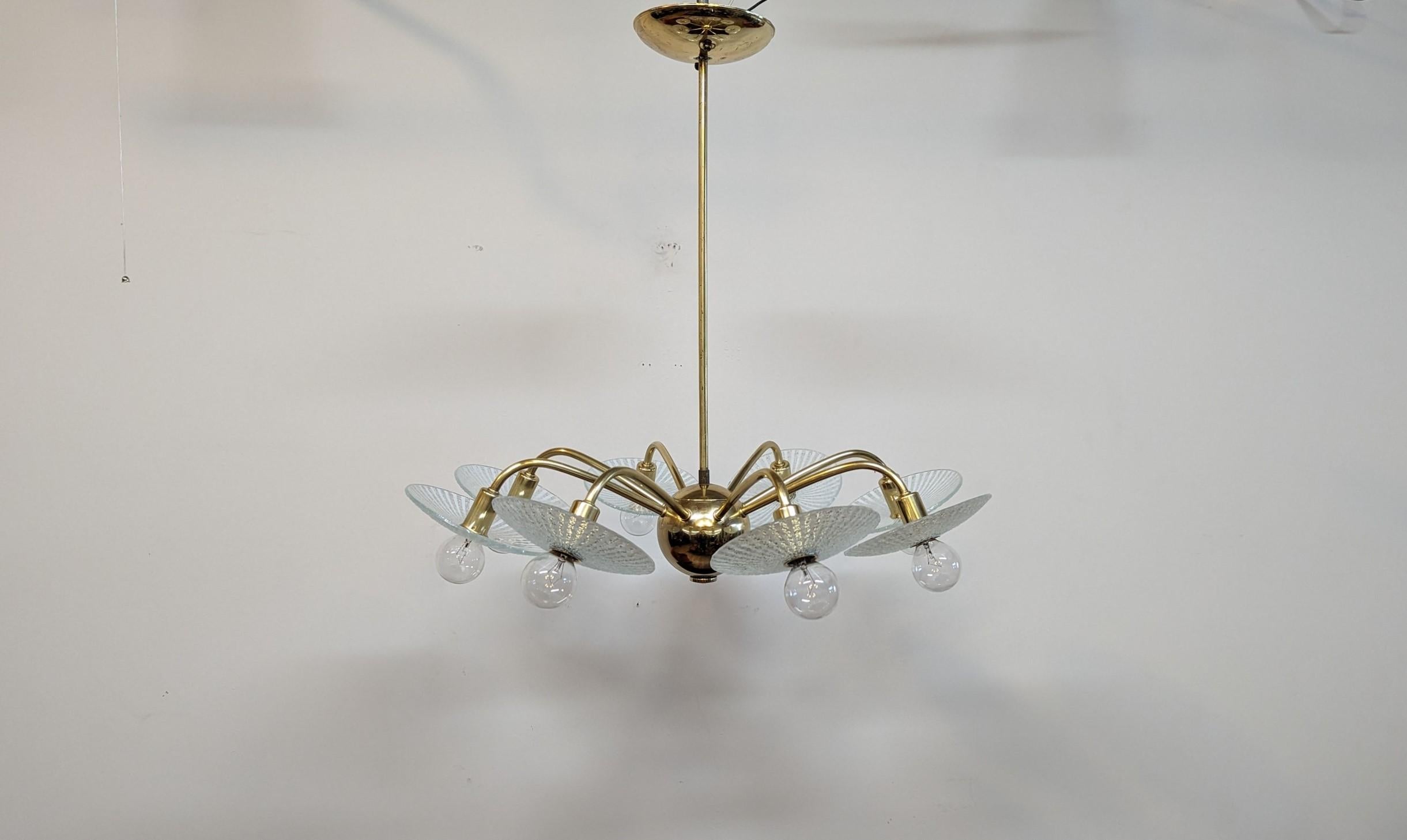 Brass Mid Century Modern Chandelier.  Mid Century Brass Sputnik eight arm chandelier with glass diffusers in the style of Lightolier.  The glass diffusers are reverse painted with tapering white lines on the backside.  The front sides of the glass