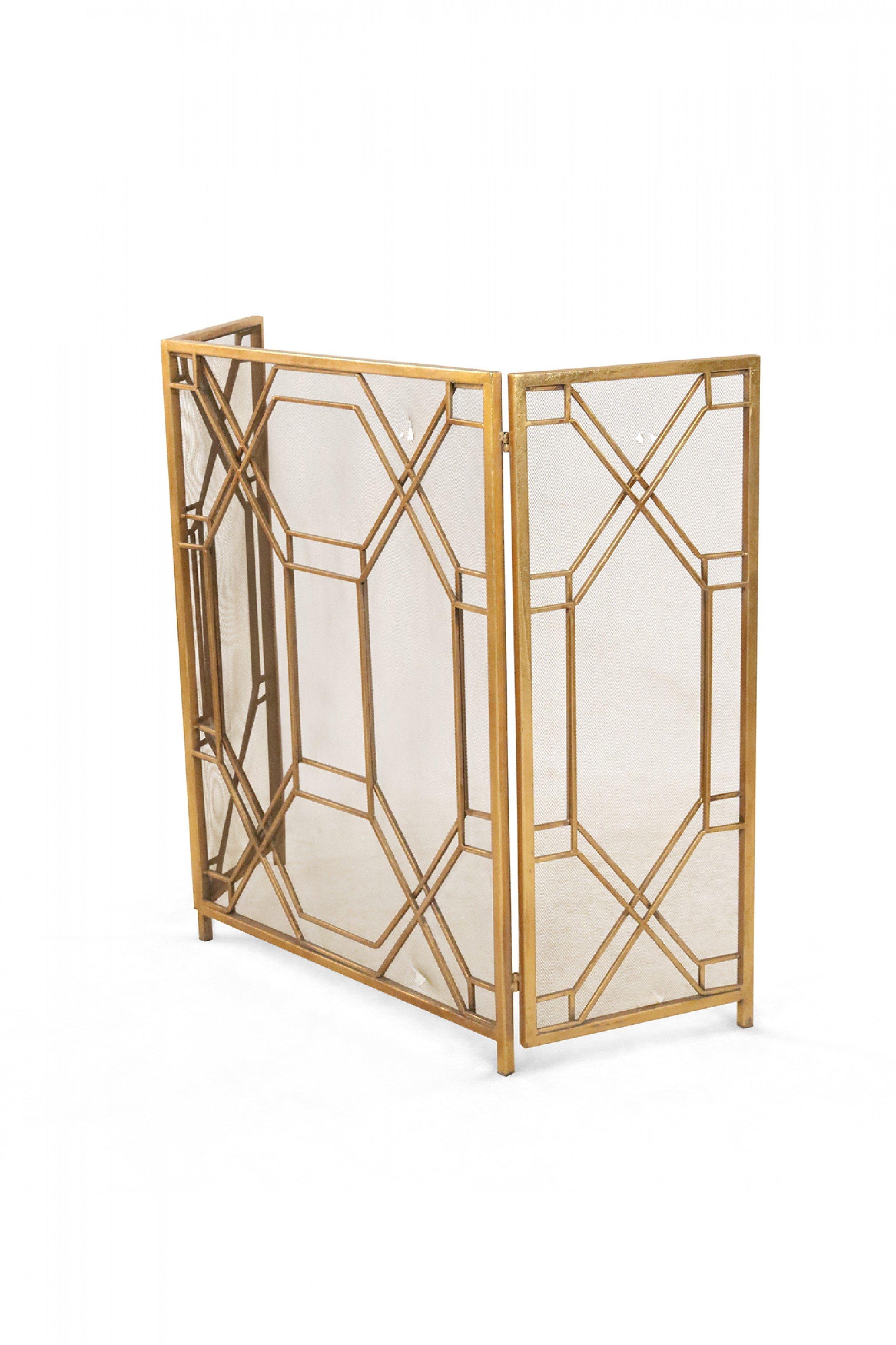 Mid-century brass framed tri-fold fire screen with screen wire panels and geometric design.
 