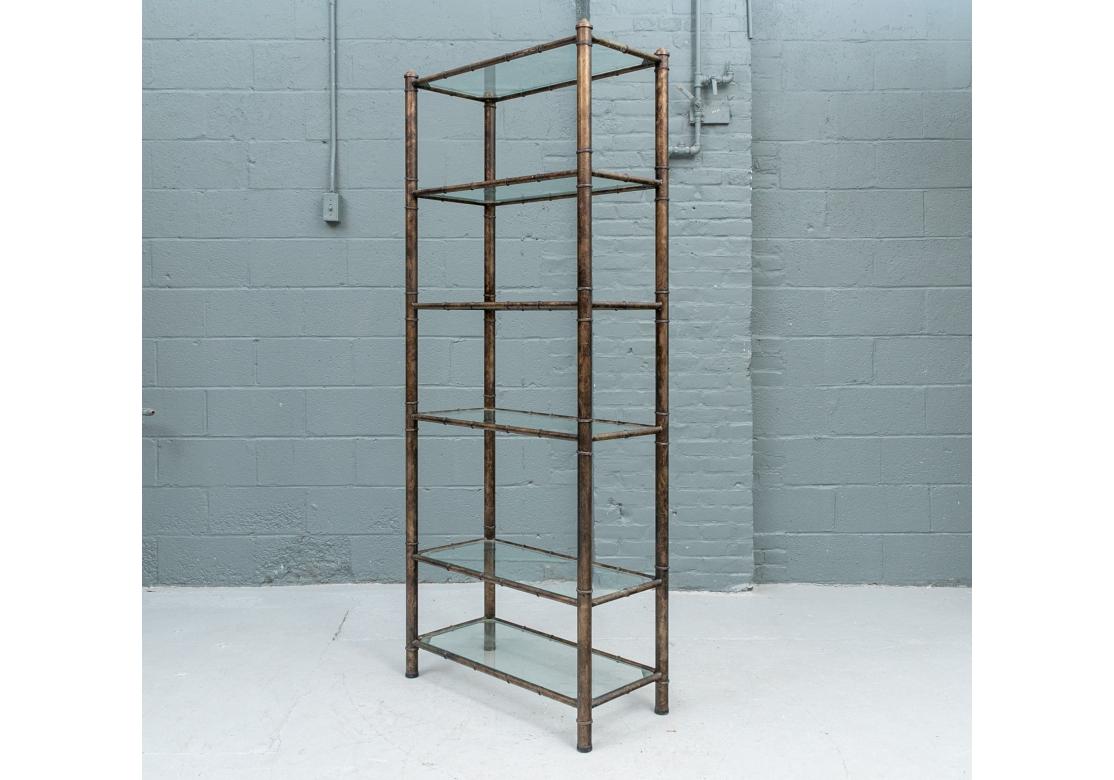 A Mid Century in Faux Bronze finish brass having a Bamboo form with 5 glass shelves having cantered corners. Ringed elements creating bamboo form elements. 

Dimensions: 74 1/4
