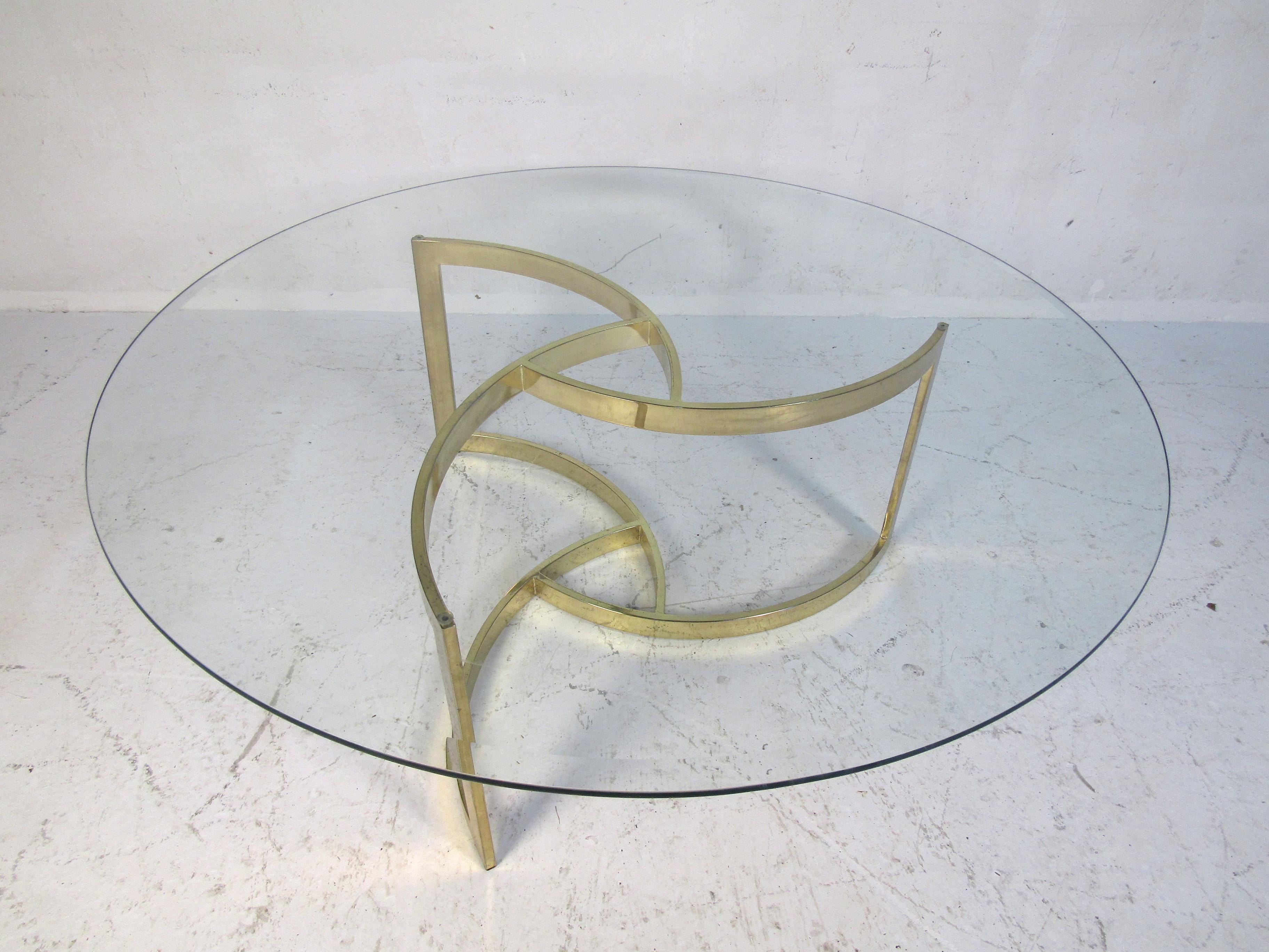 Sleek modern style table with round beveled glass top on a polished brass base.
(Please confirm item location - NY or NJ - with dealer).
 