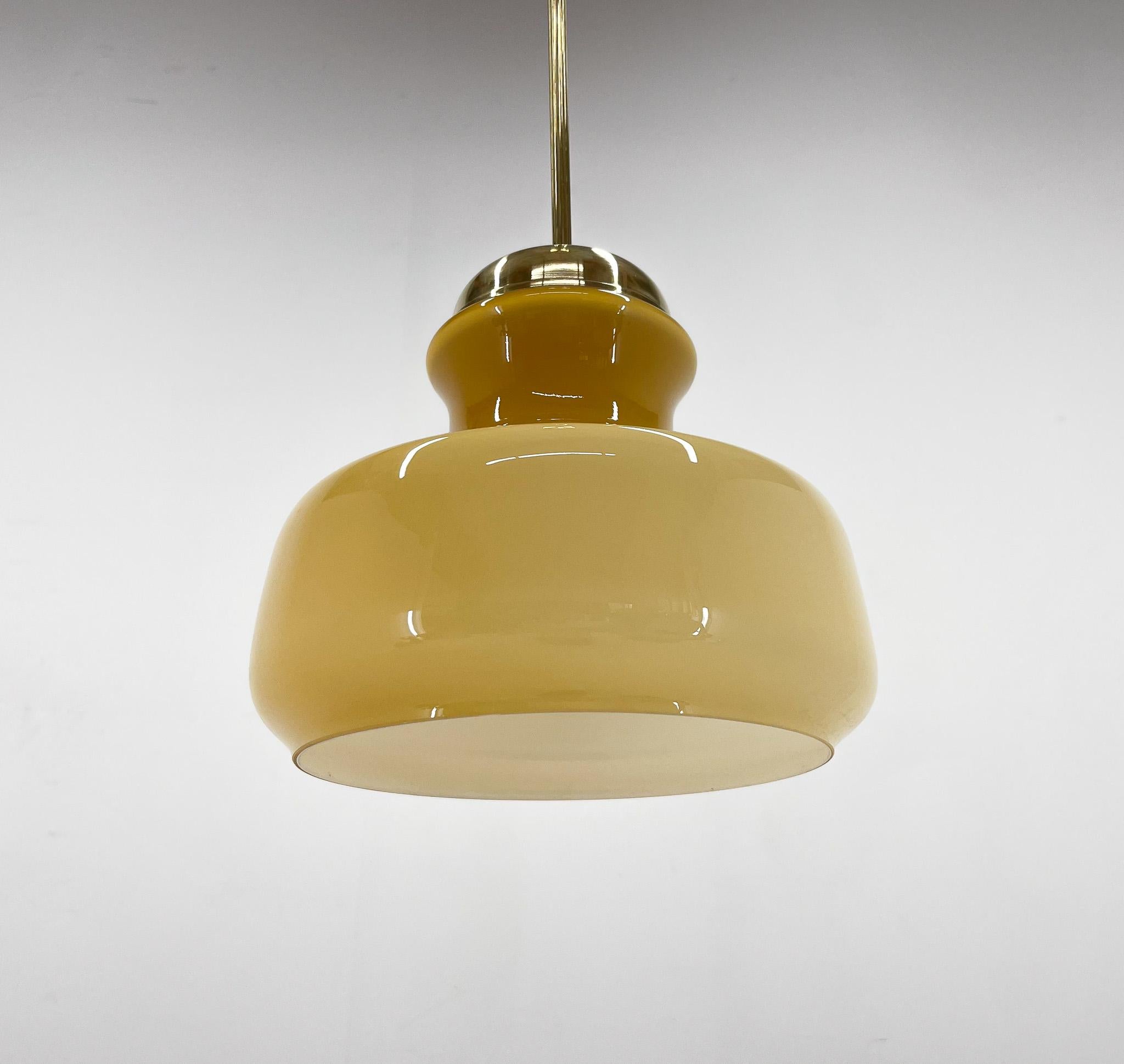 Vintage pendant light produced in former Czechoslovakia in the 1970's. Made of glass and brass. 
Restored, rewired. Bulb: 1 x E25-E27. US wiring compatible.