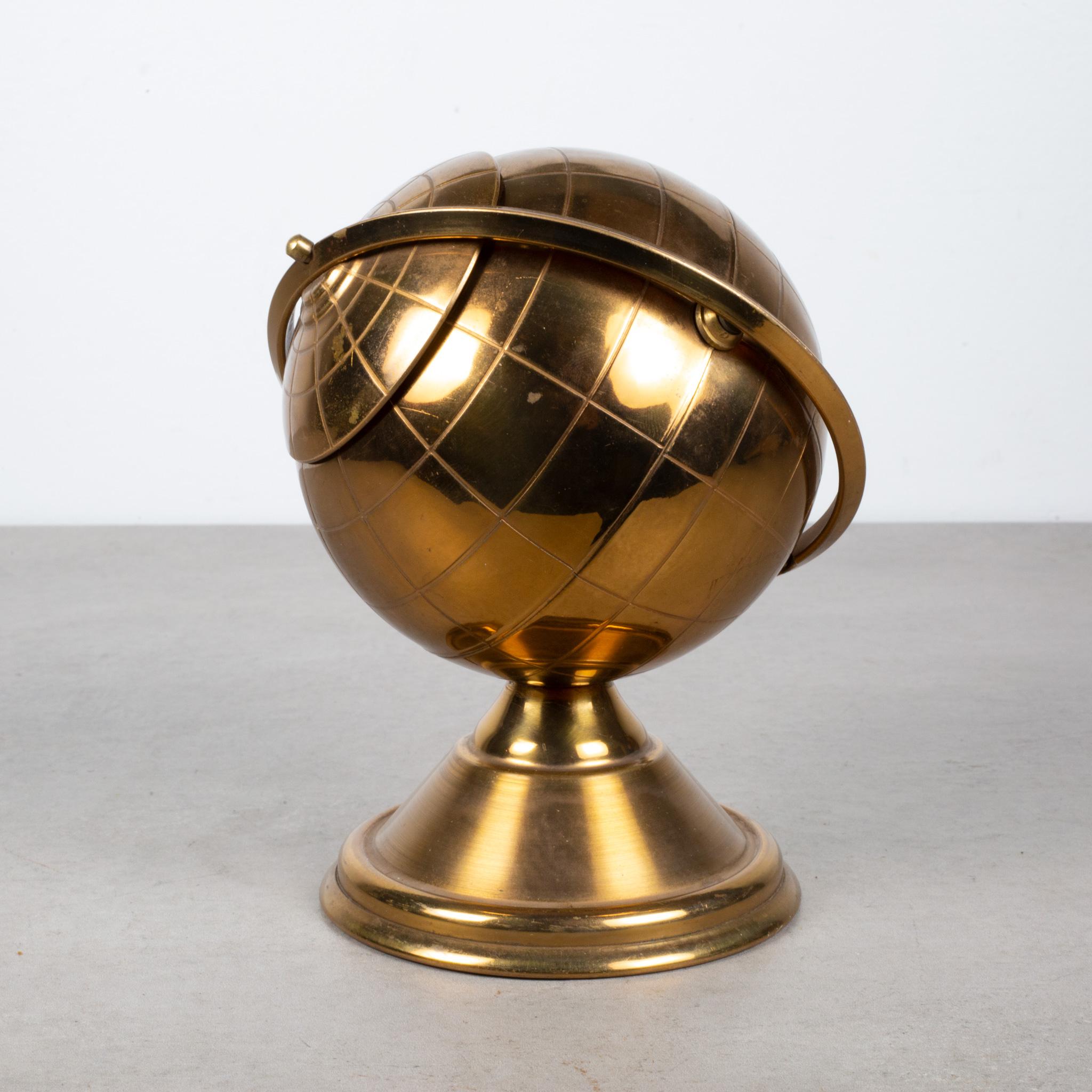 ABOUT

This is an original midcentury brass cigarette holder. The lid slides open on the globe's axis to reveal a metal interior designed to hold cigarettes. This globe is unique because it has a leather nameplate on the bottom. This piece has