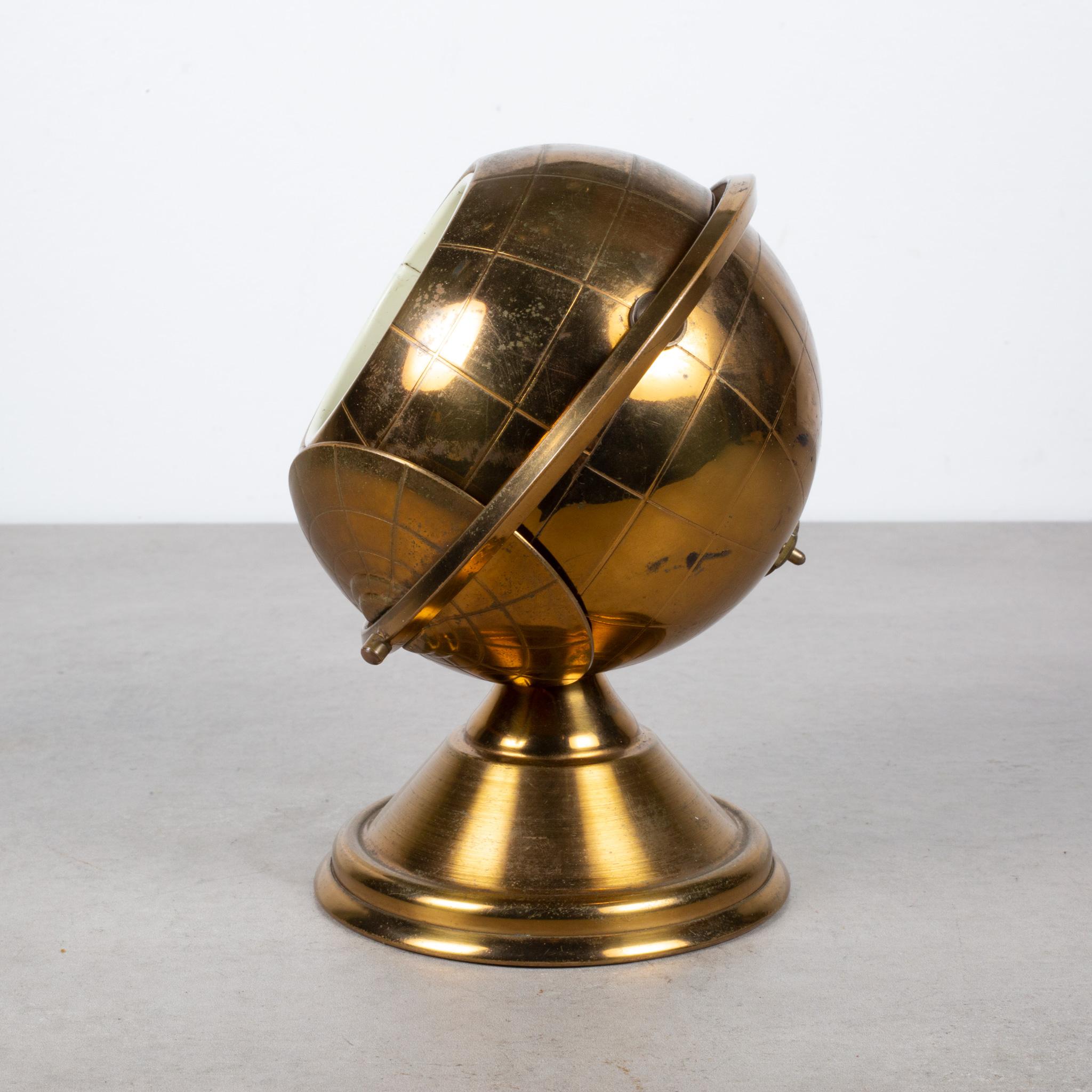 ABOUT

This is an original midcentury brass cigarette holder. The lid slides open on the globe's axis to reveal a metal interior designed to hold cigarettes. This globe is unique because it has a leather nameplate on the bottom. This piece has