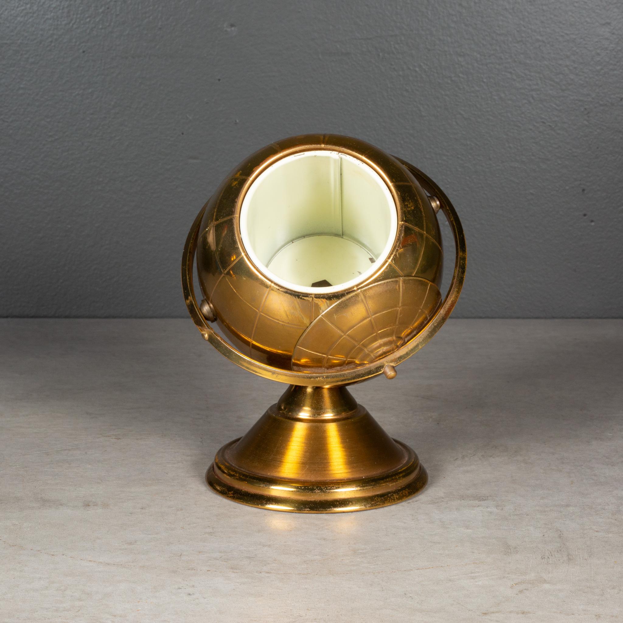 ABOUT 

An original mid-century brass cigarette holder. The lid slides open on the globe's axis to reveal a metal interior designed to hold cigarettes. This piece has retained its original finish and has the appropriate finish for the age and use.

