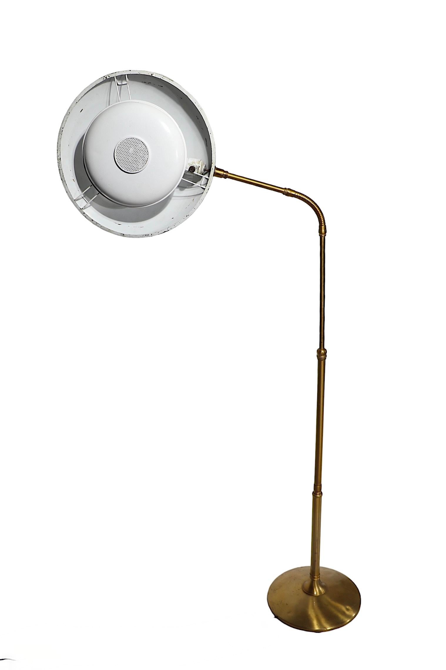 Rare early Mid Century adjustable floor lamp, designed by Gerald Thurston for Lightolier, c 1950/1960. The lamp features the classic saucer shade, with its original diffuser still in place, a flex arm attached to  the vertical pole, on a disk base.