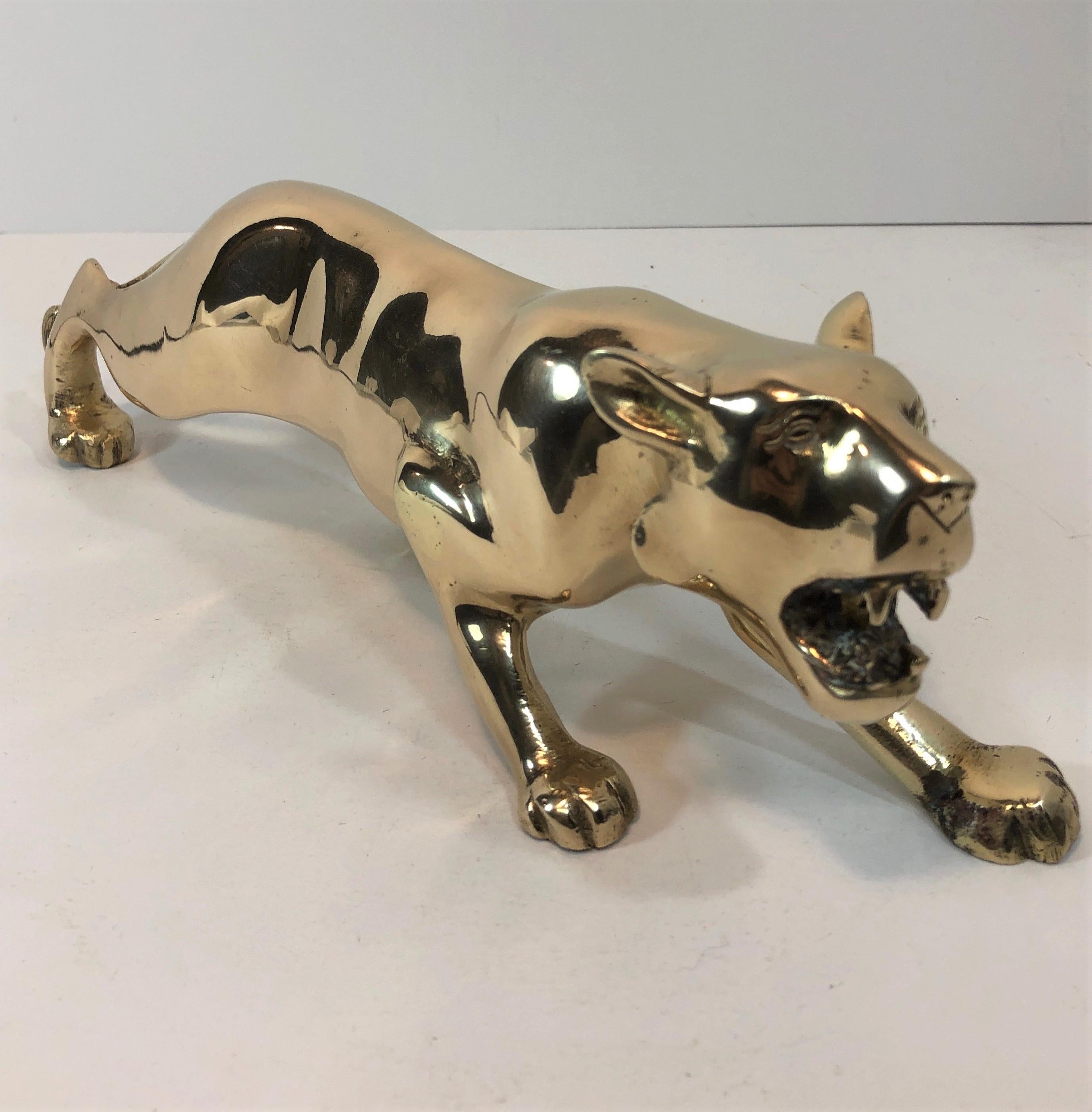 Nice heavy midcentury brass panther sculpture. In hunting stance. Nice details in casting. Dark area in photos is reflection. Nice overall condition. Hand polished.