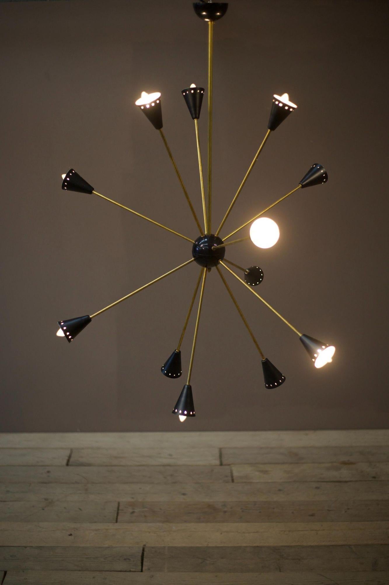 
This is a very stylish mid-century Italian ceiling light by Stilnovo. Made from brass with a black shade. The overall design is effortlessly stunning with its minimal profile and sleek nature. The multi arm design makes it a real statement in an