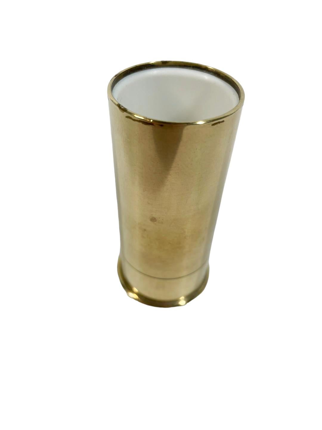 Mid-century brass shotgun shell spirit measure with plastic liner, the words 