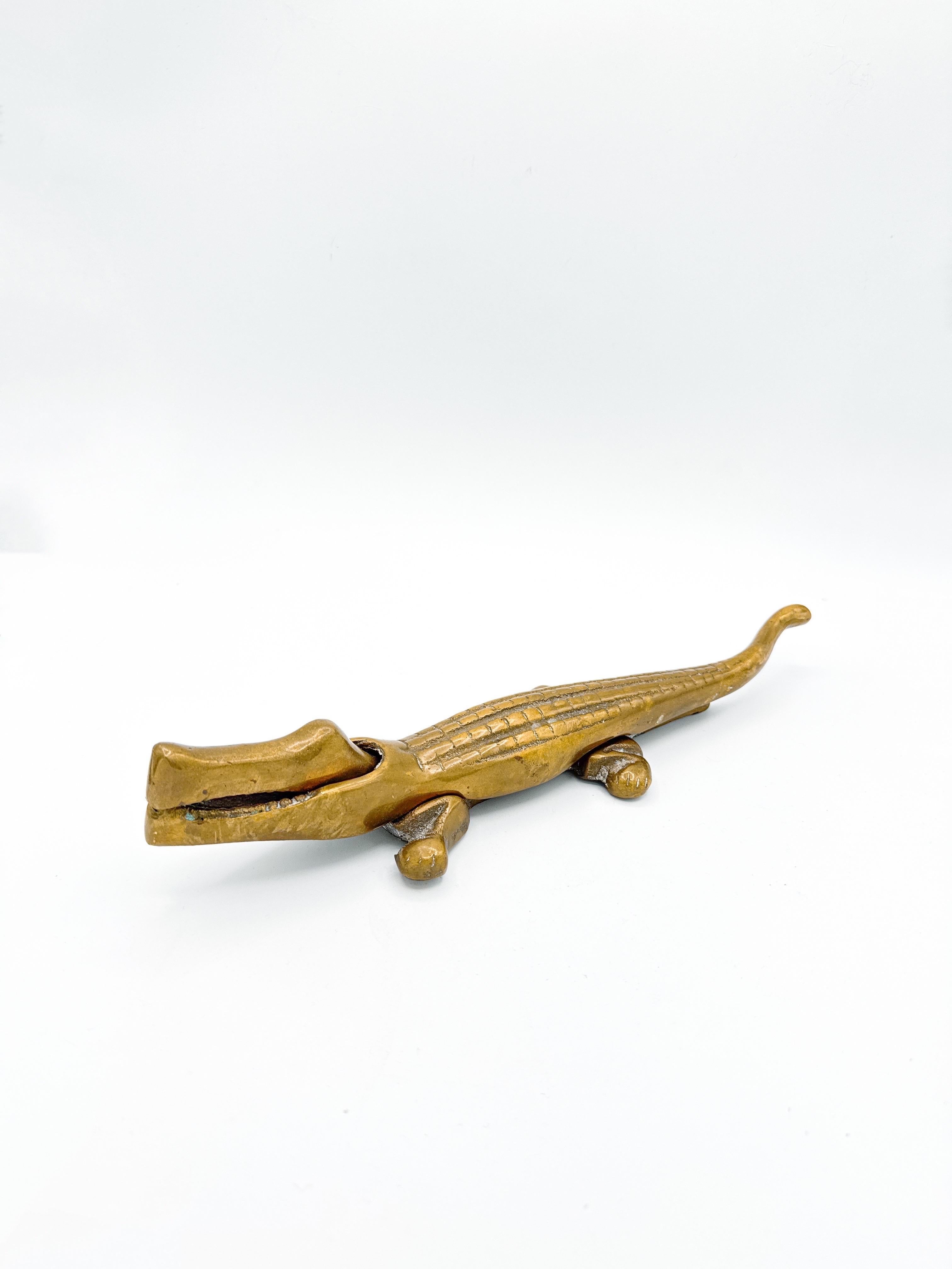 Charming and functional, this Mid-Century Modern brass crocodile nutcracker is attributed to Austrian designer Walter Bosse and dates to the 1950s. Made from solid brass, this sculptural piece blends playful form with utility—a hallmark of