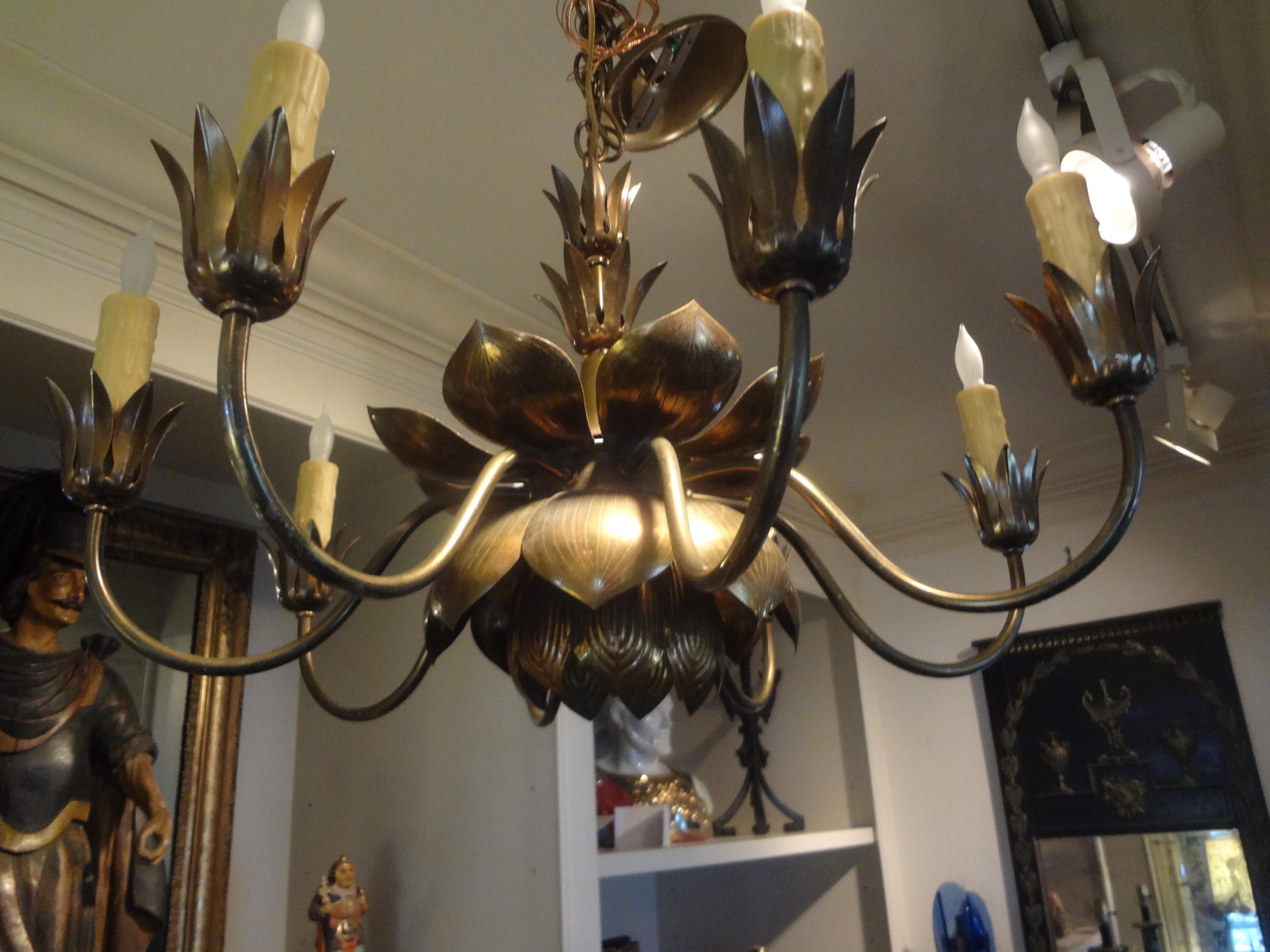 Beautiful mid-century Asian modern eight-light brass lotus chandelier by Feldman Lighting Co. This Hollywood Regency brass lotus chandelier has been newly wired with new sockets and includes one downlight in center lotus of fixture. Great patina