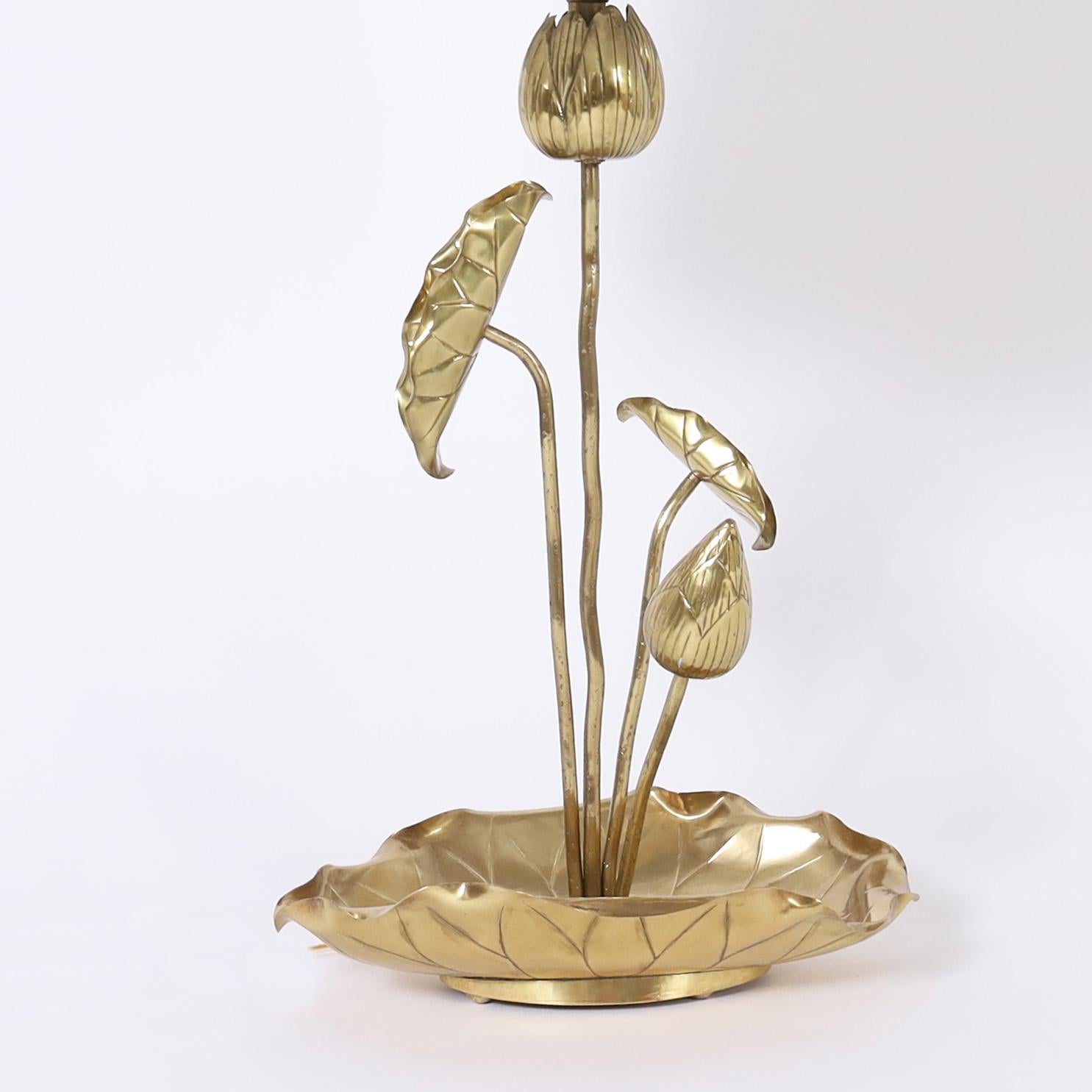 Chic vintage table lamp crafted in brass depicting lotus flowers and leaves in an organic arrangement, hand polished and lacquered for easy care.
