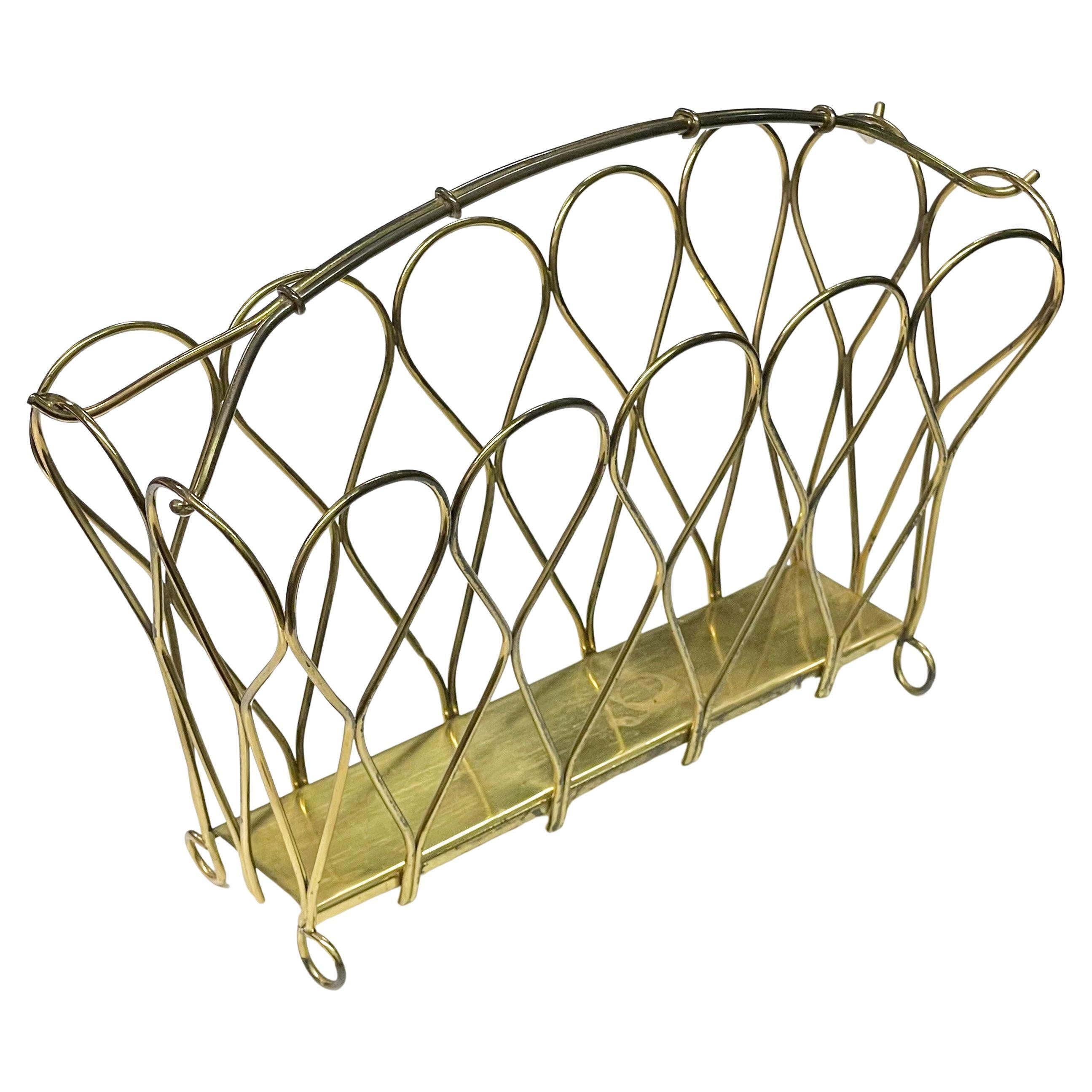 Stylish Mid Century Brass Magazine / Newspaper Rack. Believed to be produced Switzerland in the 1950’s.
Measurements: Height: 38cm  Width: 42 cm  Depth: 27 cm