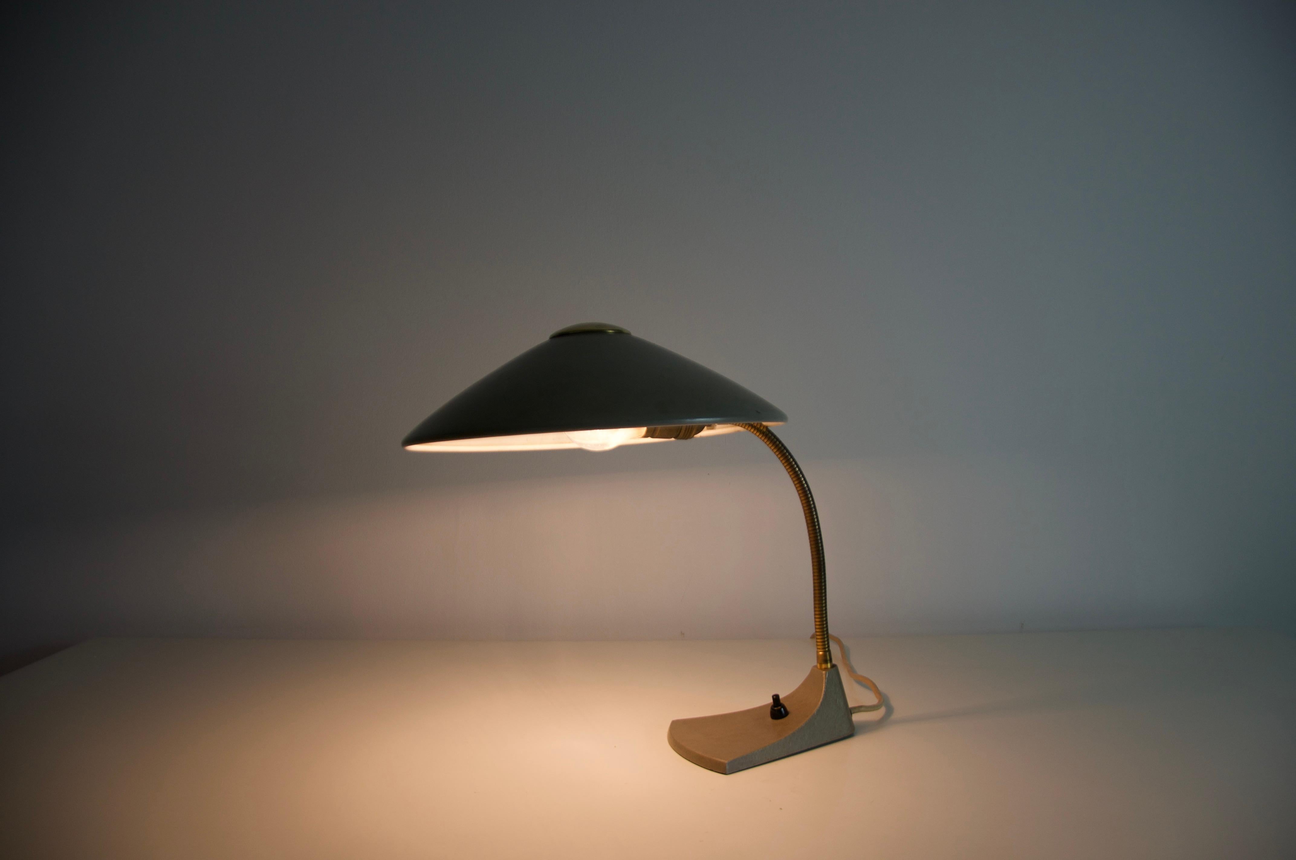Diese aus dem Deutschland der 1960er Jahre stammende Mid-Century-Tischleuchte aus Metall verkörpert die klassische Eleganz und das funktionale Design dieser Zeit. Das Metall hat im Laufe der Zeit eine reiche, warme Patina entwickelt, die seinen