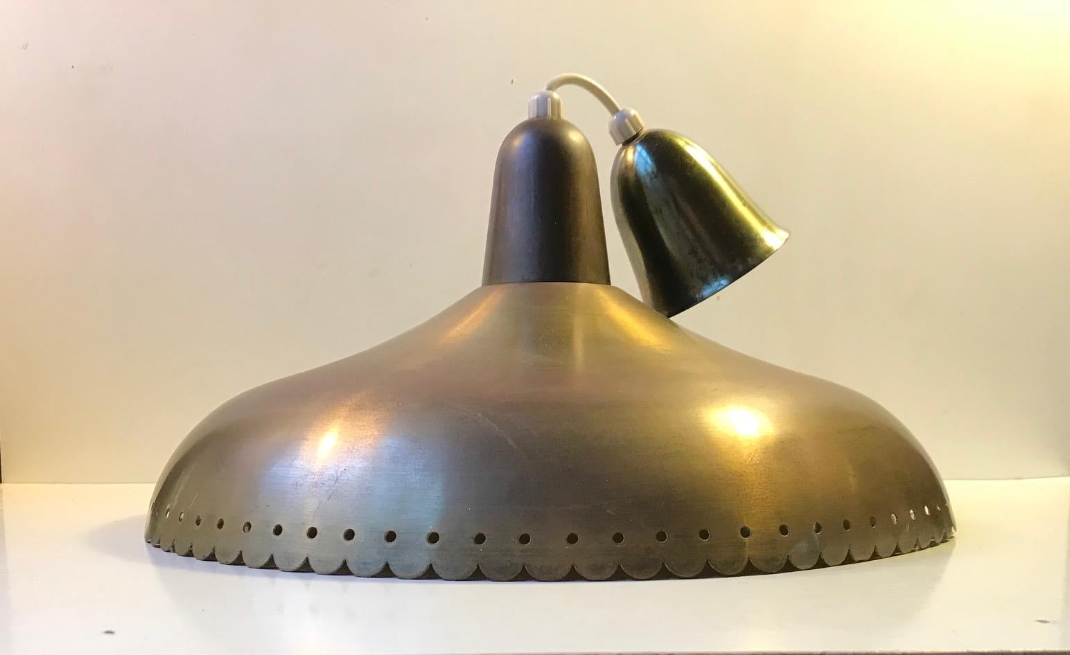 Danish ceiling light designed by Bent Karlby for Lyfa, Denmark and manufactured in the early 1960s. The light is made from solid partially perforated brass that has patinated charmingly over the years. Original solid brass canopy with similar