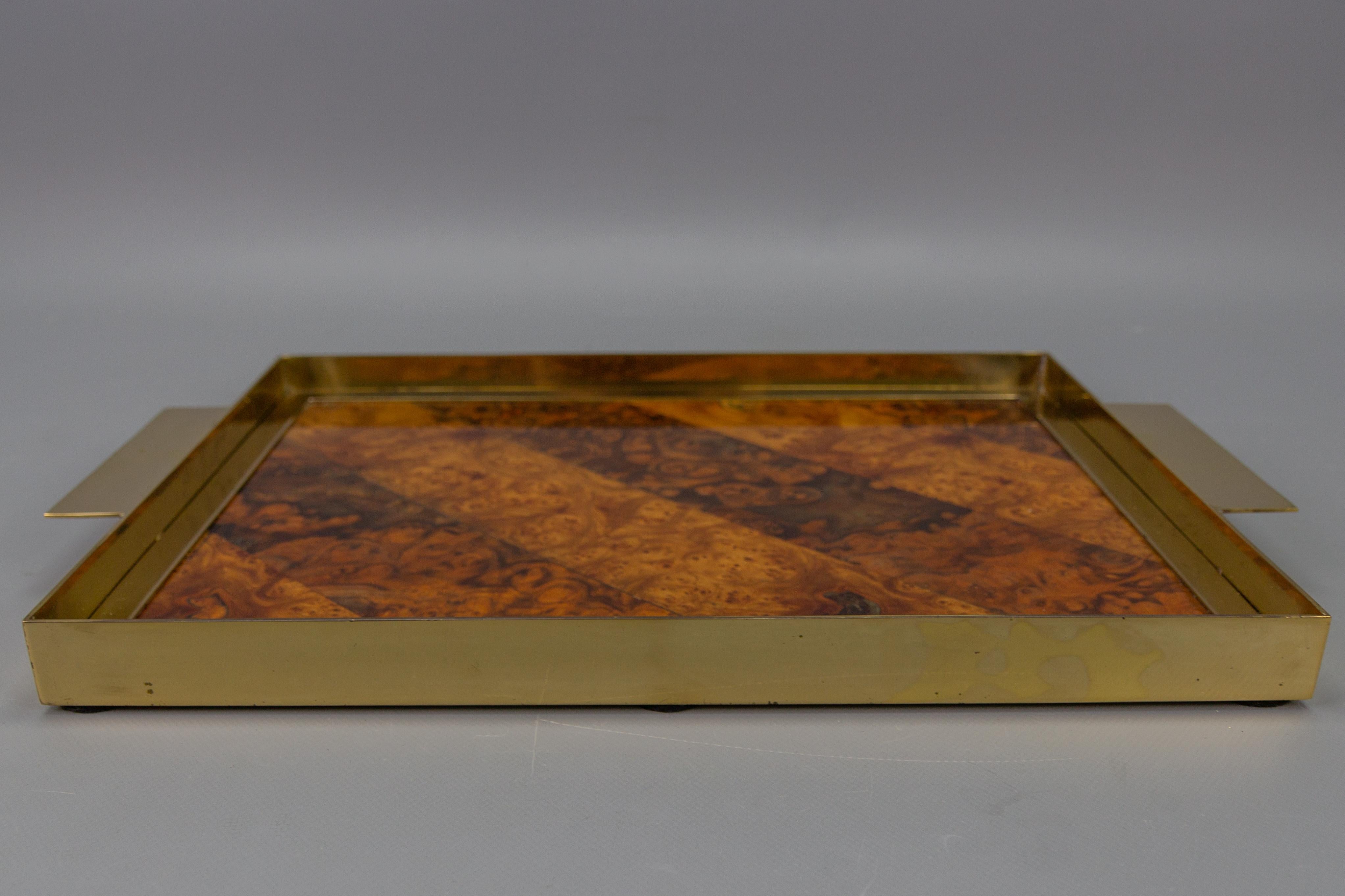 Mid-Century brass, plywood, and veneer serving tray, Italy, circa the 1960s.
An elegant serving tray from the Mid-Century Modern period, made in Italy around the 1960s. 
The tray features a base made of plywood and veneer, creating a burr wood