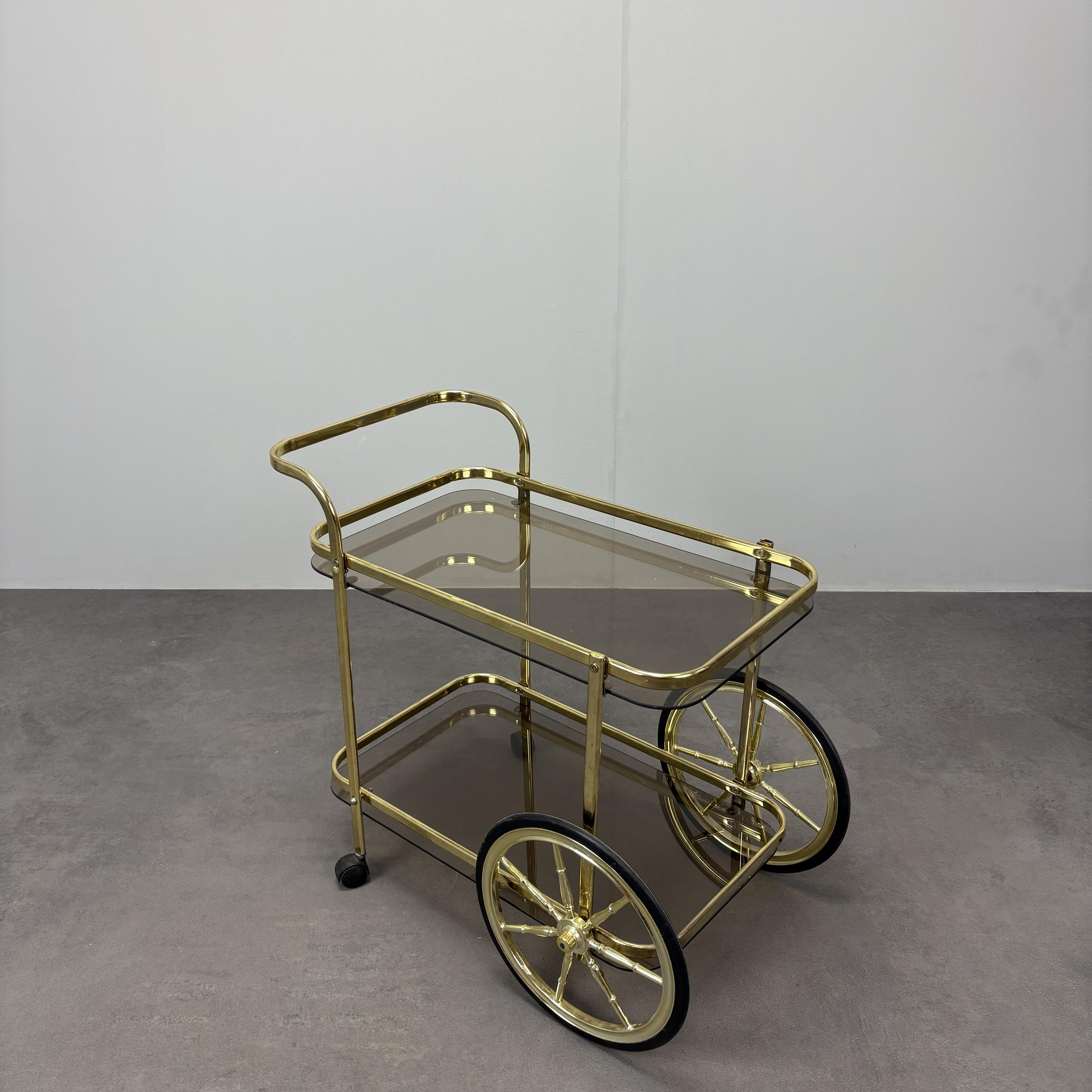 - Mid-Century Brass Serving Trolley, 1970s, Germany,
- made of Brass and Smoked Glass,
- shows signs of wear and age (scratches, etc.),
- in good original condition.