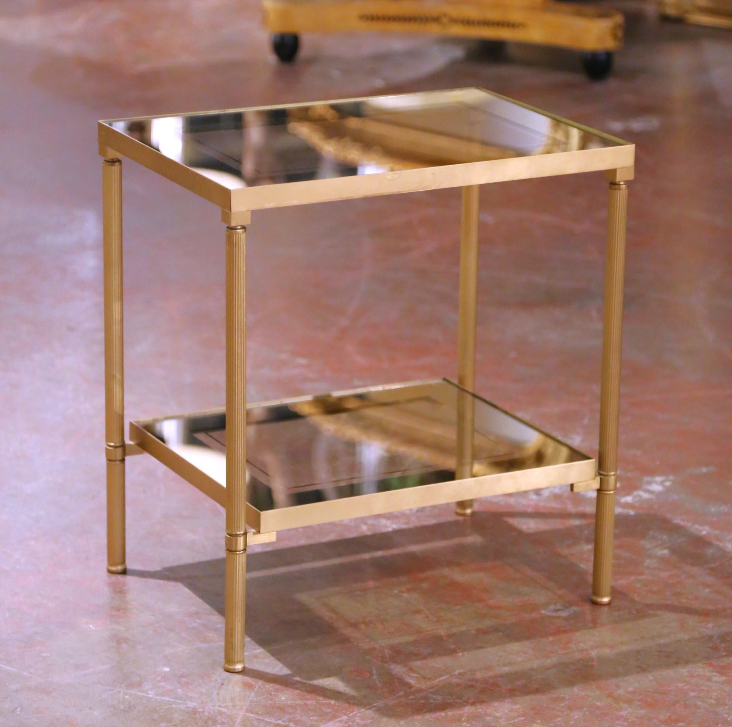 Add timeless Parisian elegance to your interior with this refined mid-century side table attributed to Maison Jansen. Crafted in France circa 1960, the piece features a gilt brass frame resting on fluted legs with ringed collars, a hallmark of