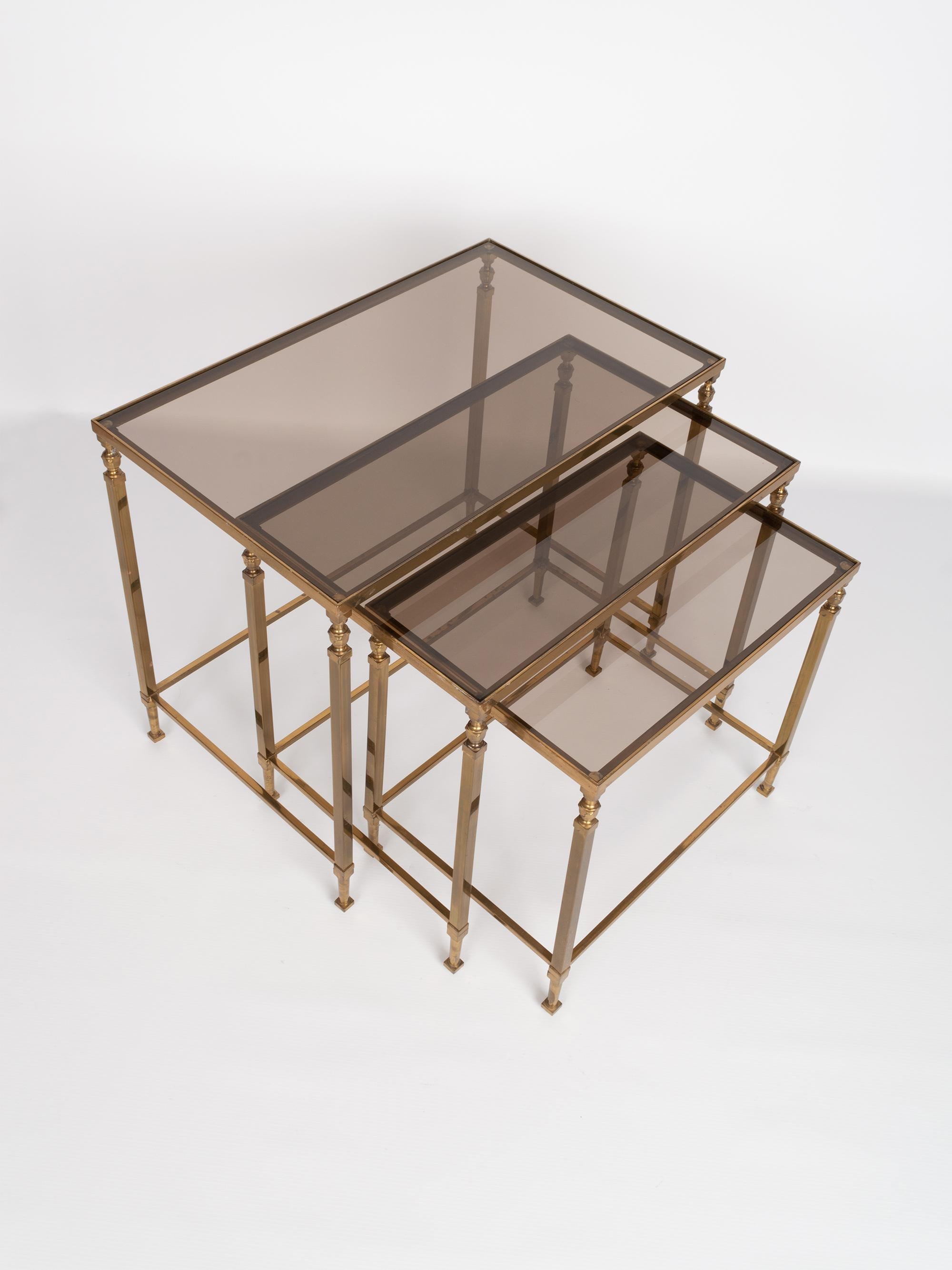 Midcentury brass and smoked glass nesting tables by Maison Baguès, France, circa 1960.
Presented in very good vintage condition commensurate of age.

Dimensions:
H 44 x W 52.5 x D 32.5 cm
H 40 x W 45.5 x D 29.5 cm
H 36 x W 38.5 x D 26.5 cm
   