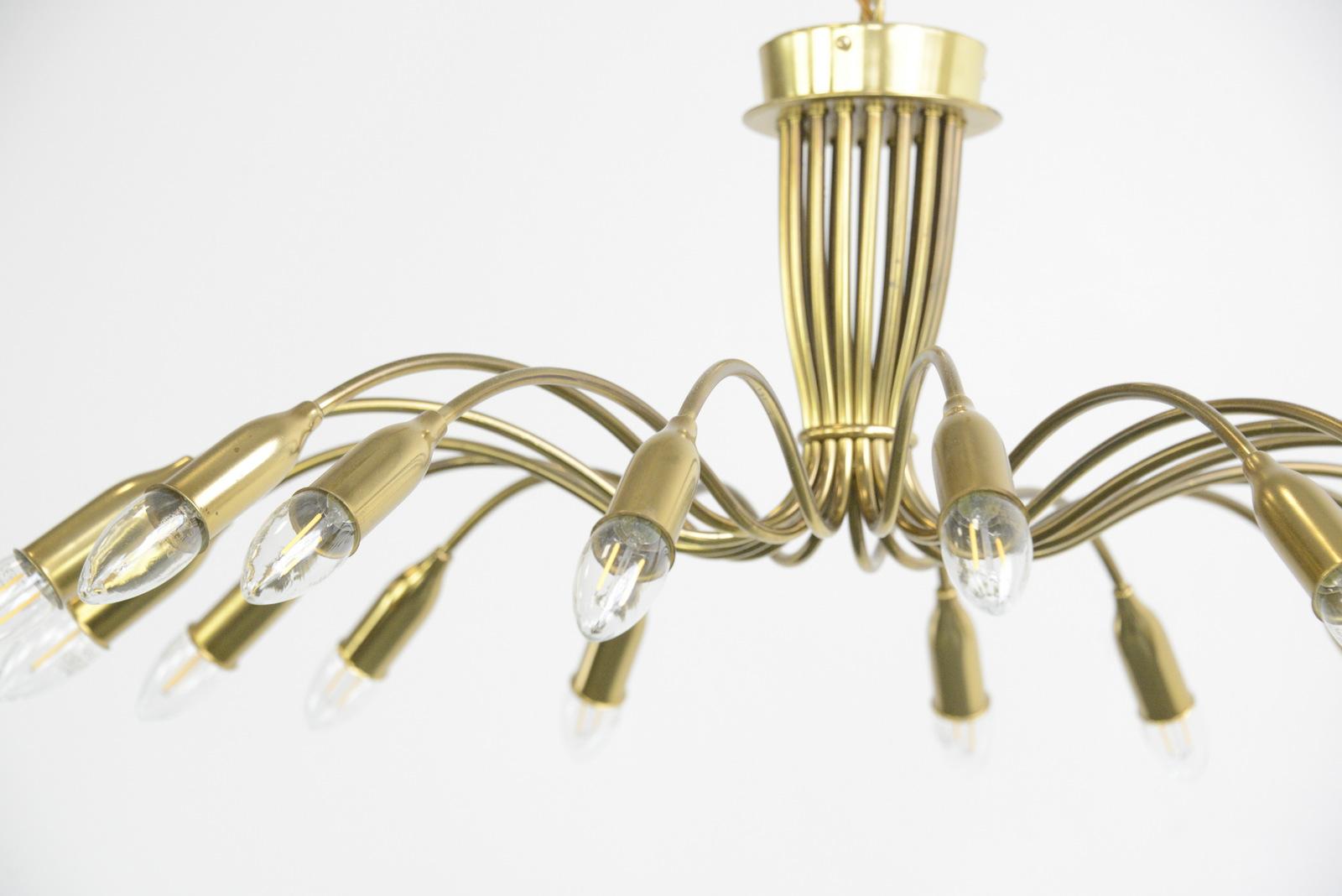 Large midcentury brass spider chandelier, circa 1950s

- Curved tubular brass
- 18 arms
- Takes E14 fitting bulbs
- Comes with brass chain and ceiling rose
- German, 1950s
- Measures: 89 cm wide x 37 cm tall

Condition report

Fully re
