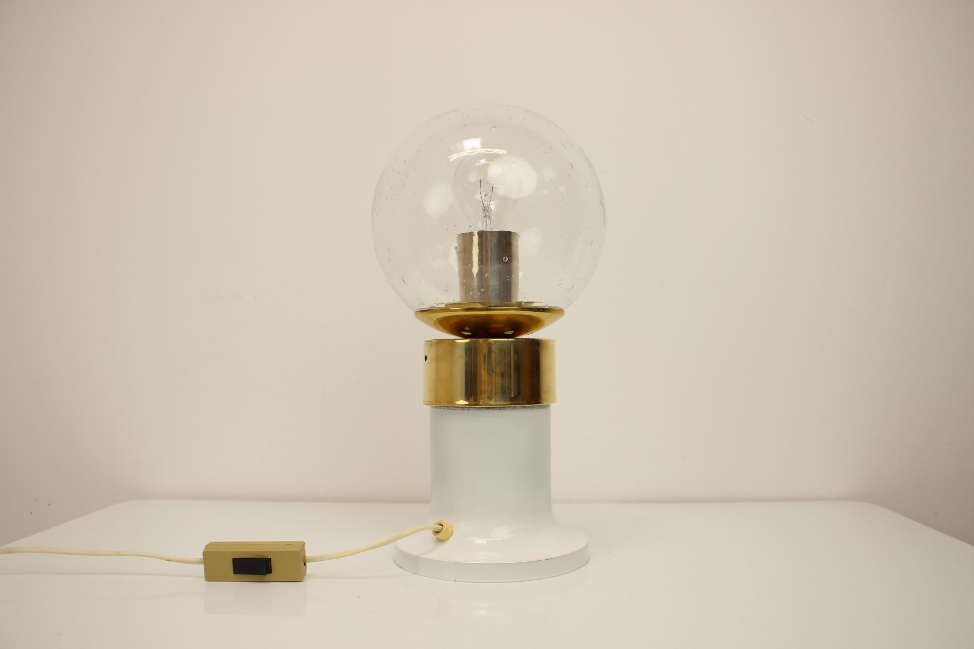 Vintage brass and glass table lamp, produced by famous Kamenicky Senov Glassworks in former Czechoslovakia in the 1960's. 
Made of brass, metal and glass.
In original condition, with a few signs of wear, repolished, cleaned.
Fully functional..
