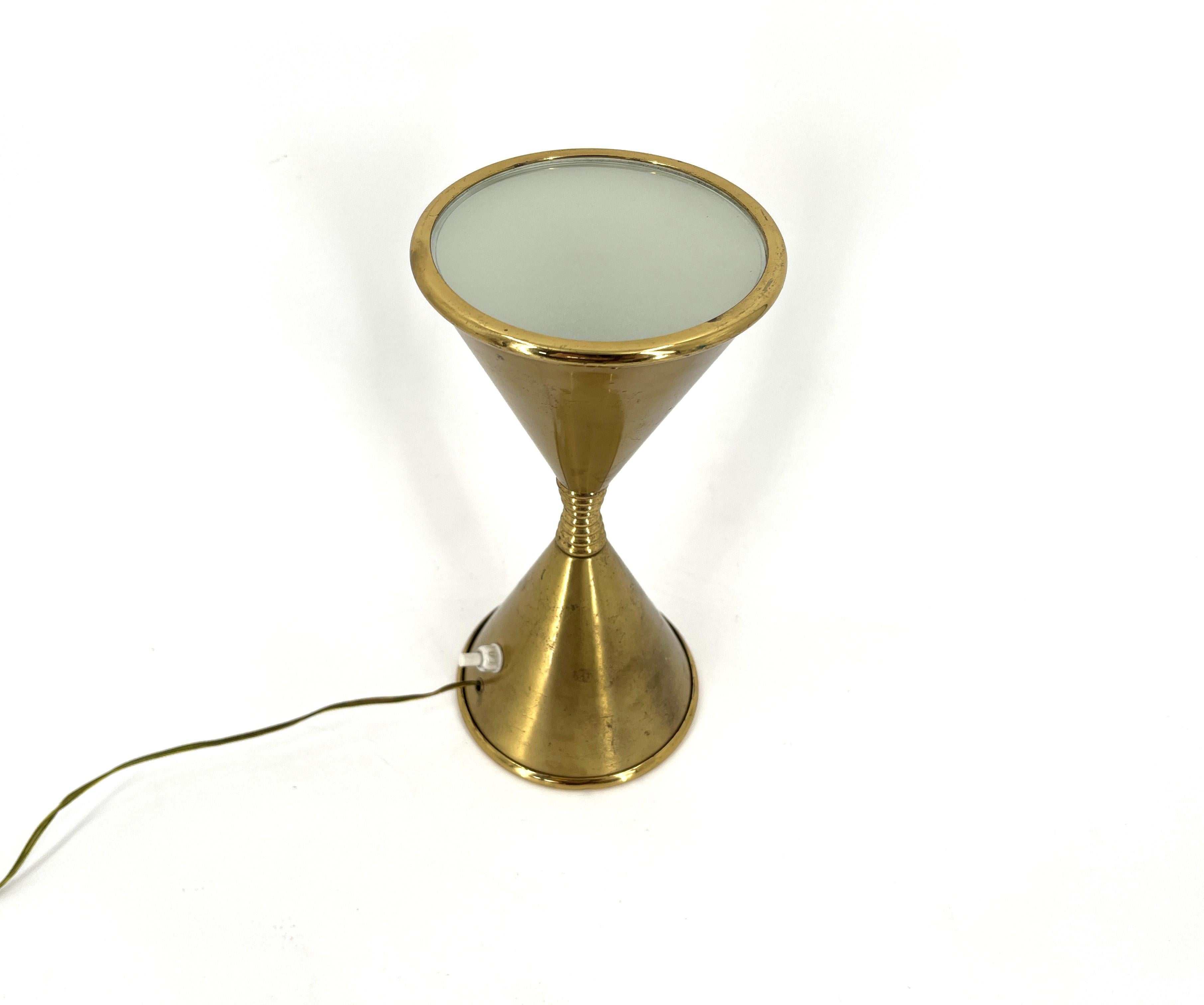 Very rare table lamp model Clessidra designed by Angelo Lelli and produced by Arredoluce in the 1960s.

This diabolo shaped lamp is fully original, with the original switch and, what's very rare' complete with the original glass lense which is