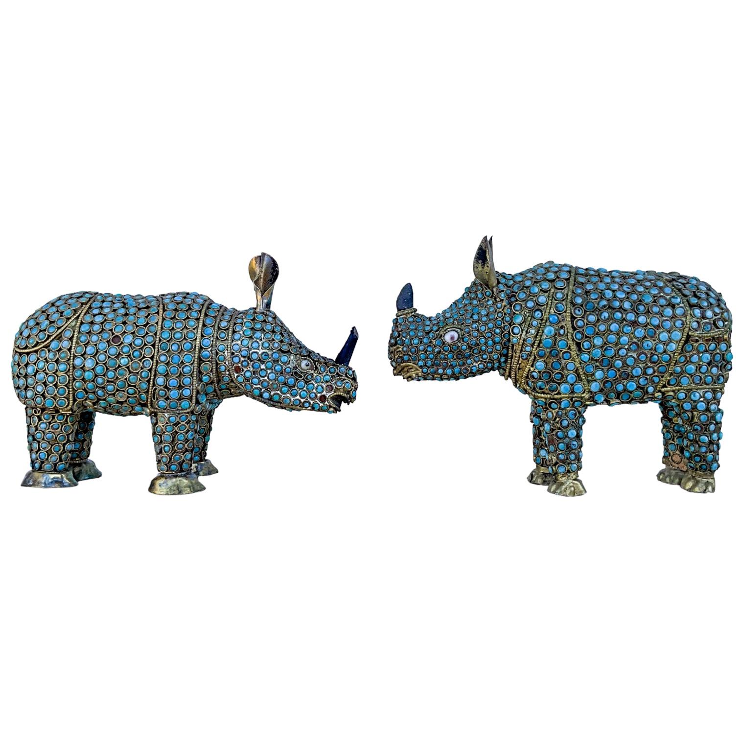 This is a set of two brass rhinos with a cloisonné style glass bead bodies. They are purported to be Tibetan. The horns are wood. The set has some lite age wear. 