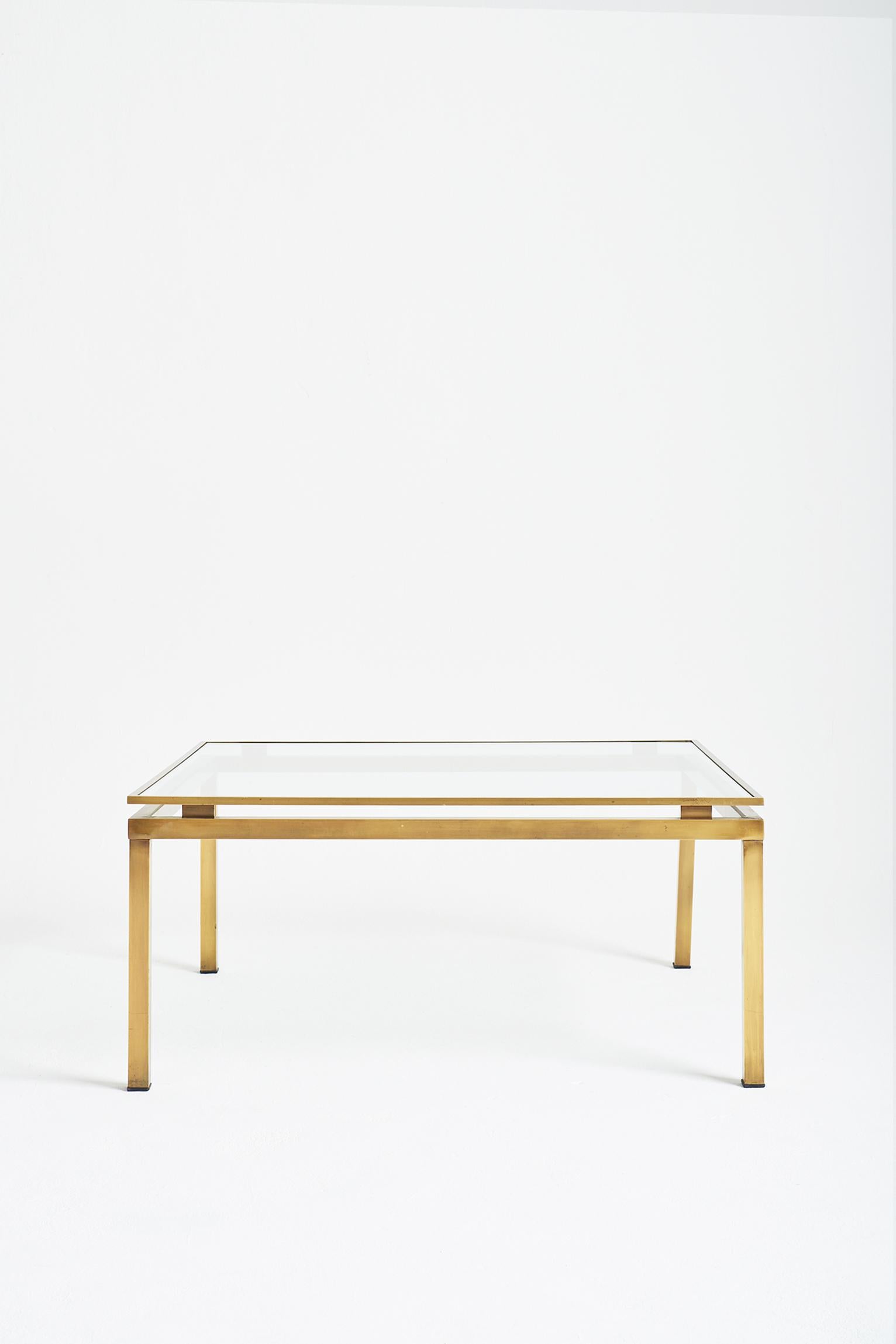 A brass and glass two-tiered square coffee table,
France, Circa 1970.