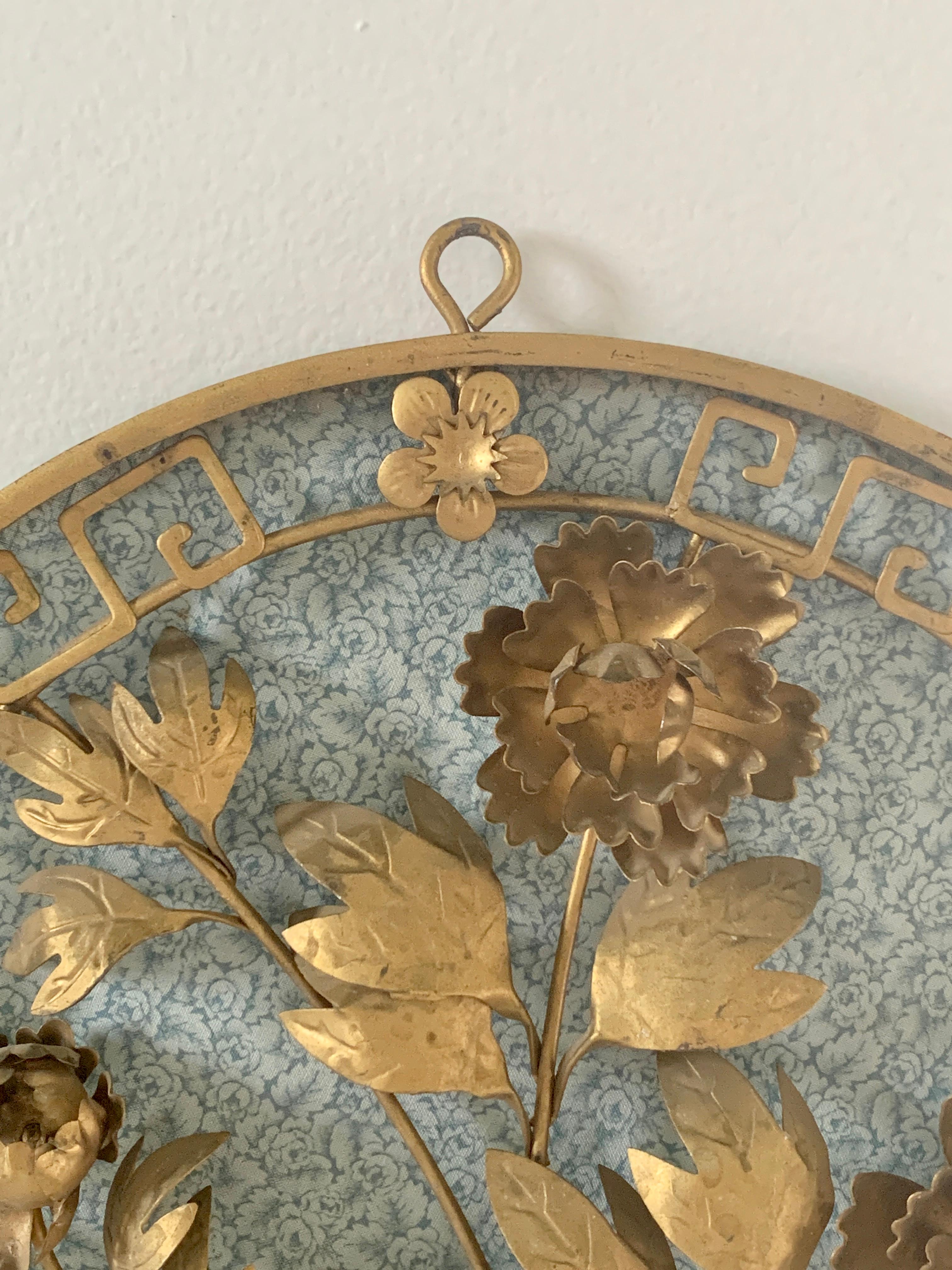 A charming pair of wall hanging medallions featuring a greek key border and floral bouquets

USA, Mid-20th Century

Brass, with blue fabric backing. Fabric can be removed or replaced with another fabric or mirror.

Measures: 12