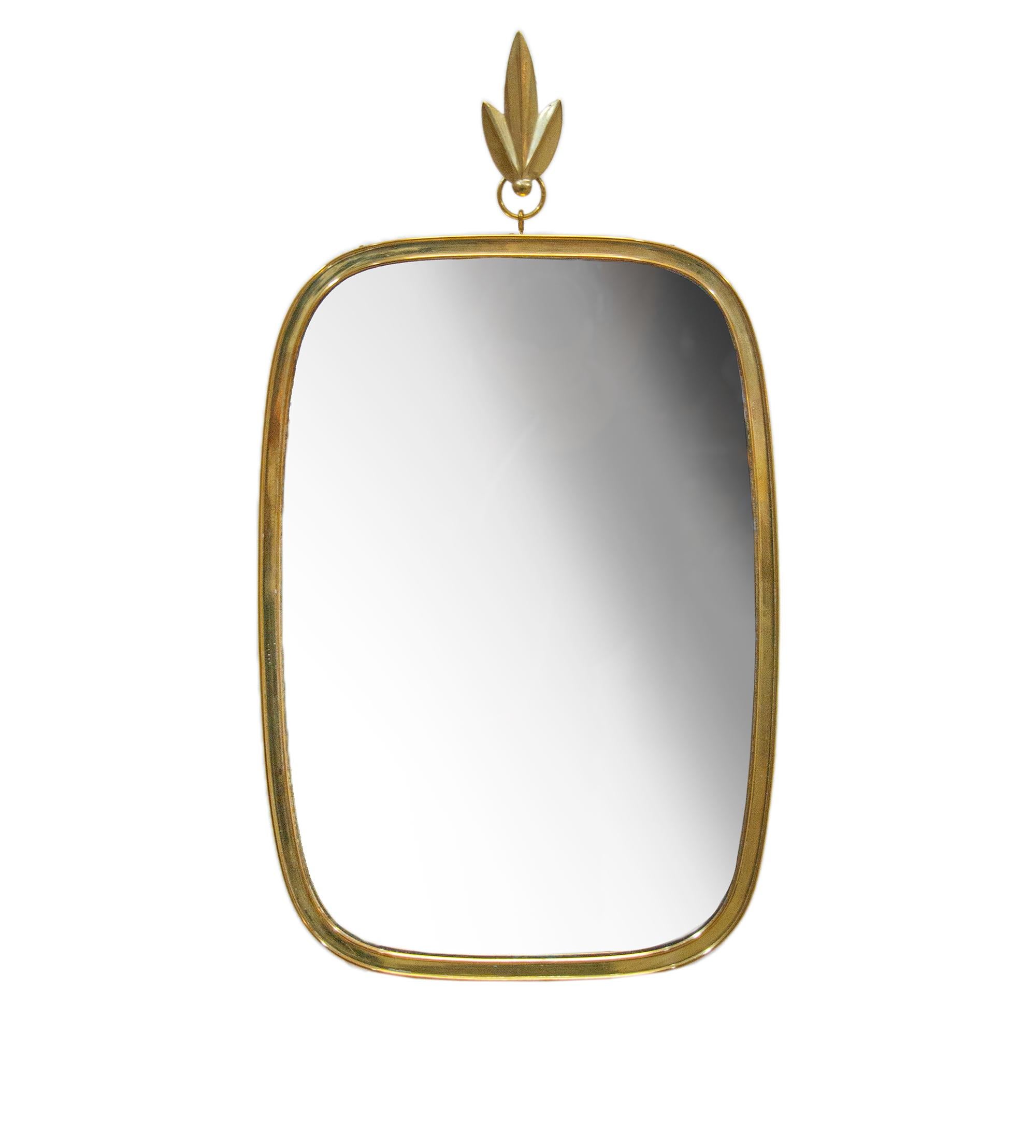 Lovely brass wall mirror manufactured in Germany in the 1950s by Vereinigte Werkstätten, Germany, Bavaria, Munich. 

Measures: height 20” in. (51 cm), width 11” in. (28cm). 
Condition: this vintage piece is in a very good original condition. 
