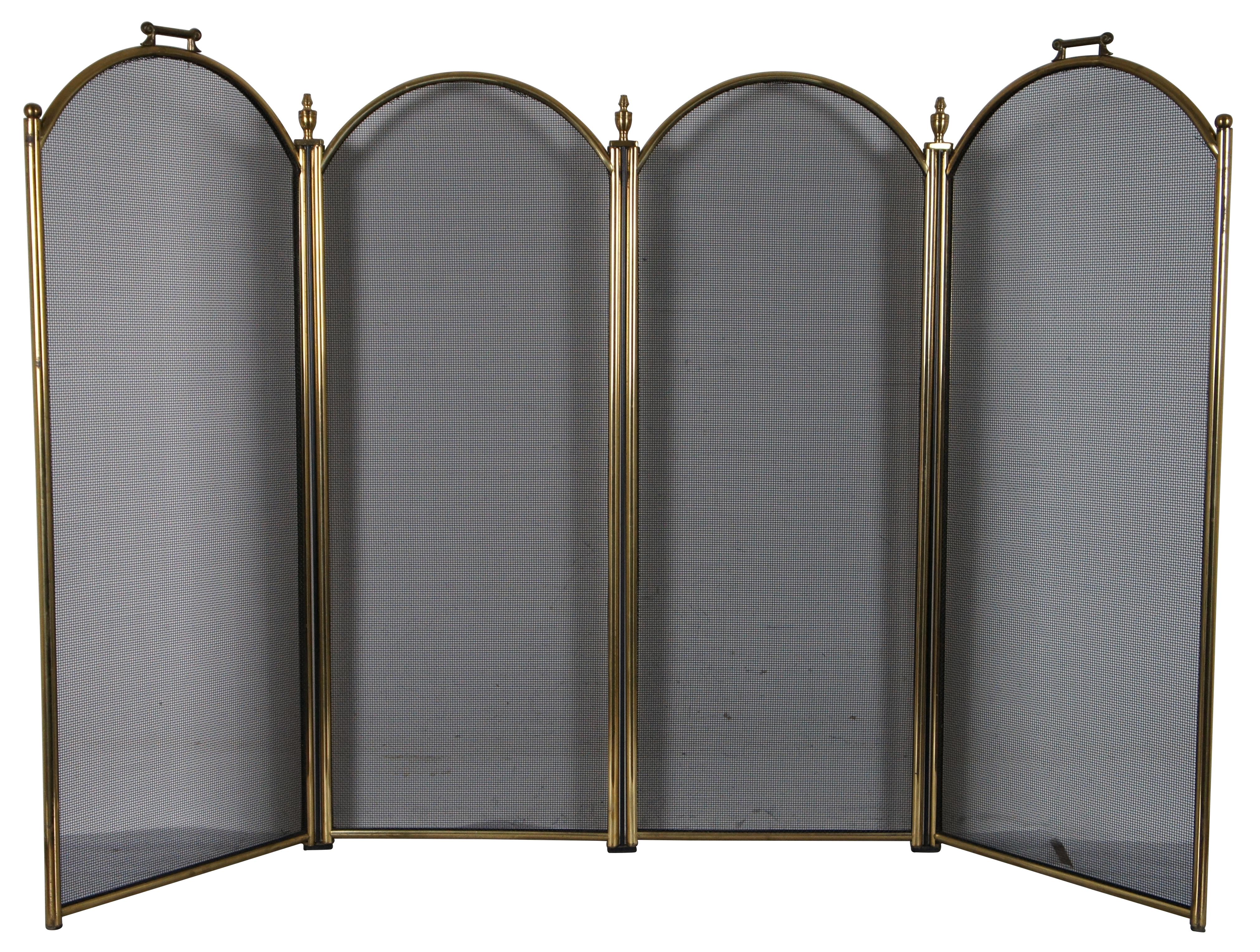 Vintage four panel polished brass and wire mesh fireplace screen featuring arched tops, turned urn shaped finials, and square handles. 18th century design. Mesaure: 35