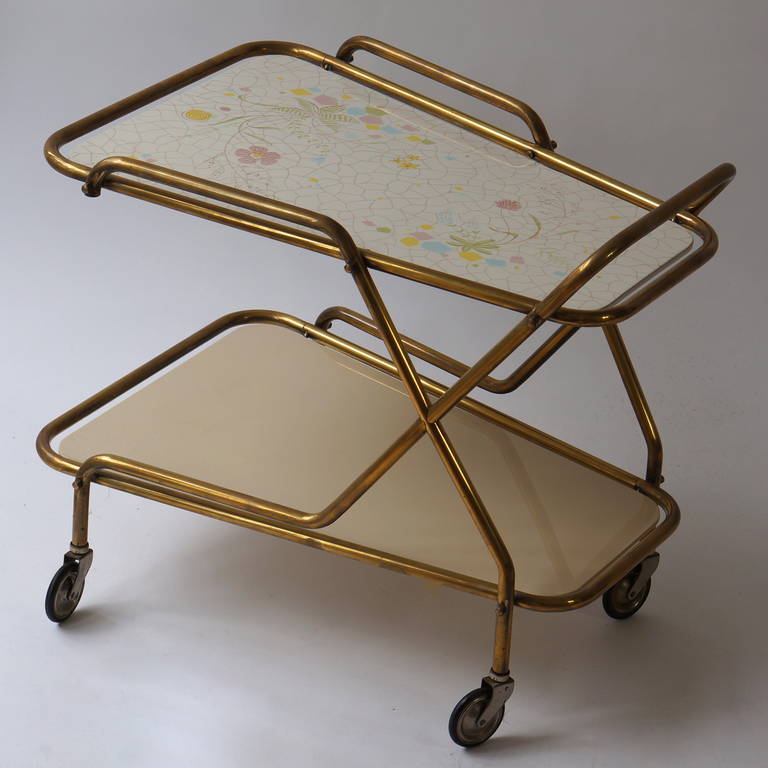 Italian brass serving table or liquor trolley.
Elegant liquor trolley or serving table with brass frame which supports the removable hand painted tray with beautiful flowers.
Quality and craftsmanship.
Measures; Height 63 cm.
Width 72 cm.
depth