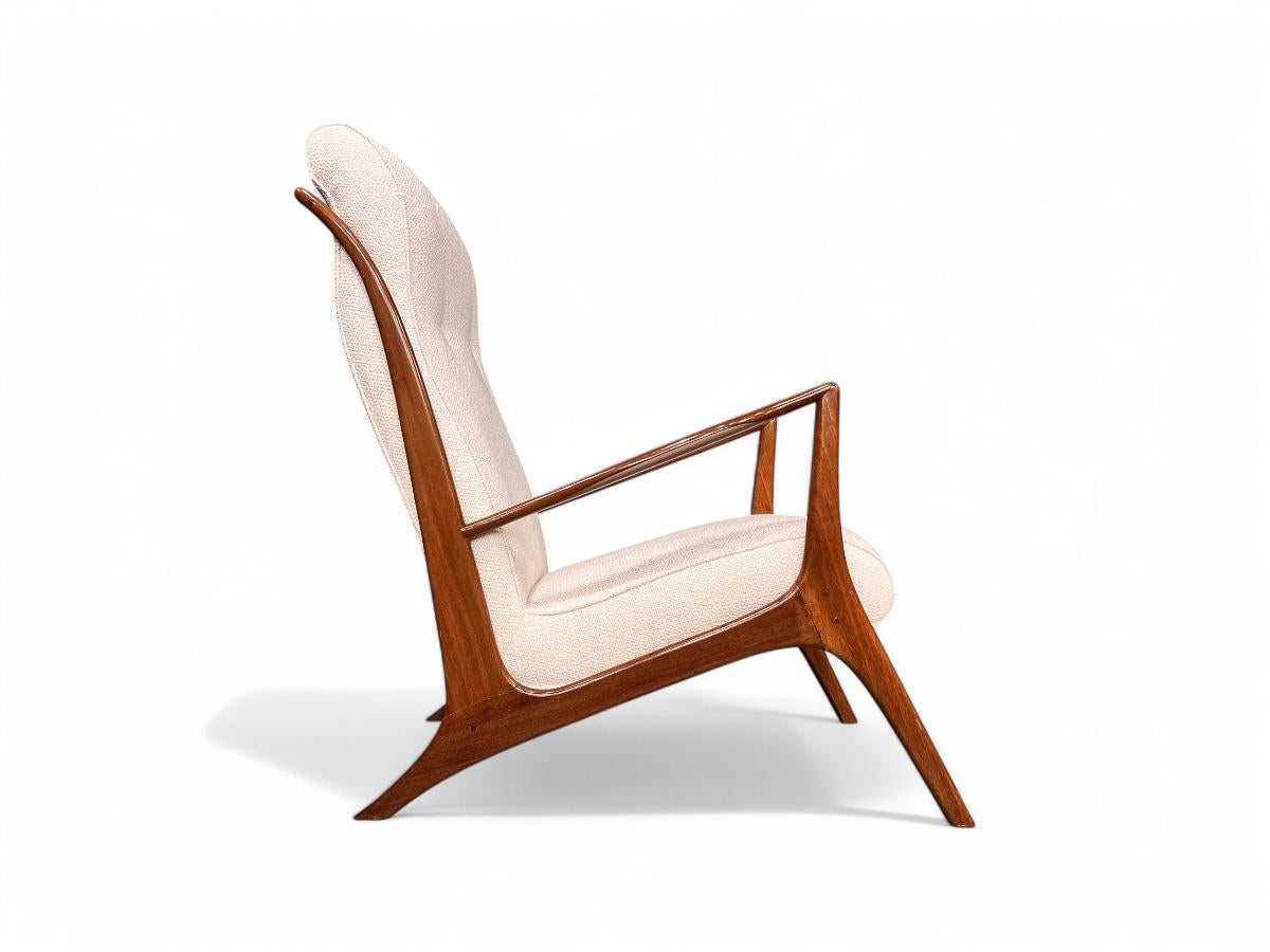 Discover the exquisite mid-century Brazilian modern armchair crafted by John Graz in the 1950s, available today! This stunning chair showcases a caviuna hardwood frame and a comfortable Beige Bouclé  seat. Boasting a low seat and an ergonomically