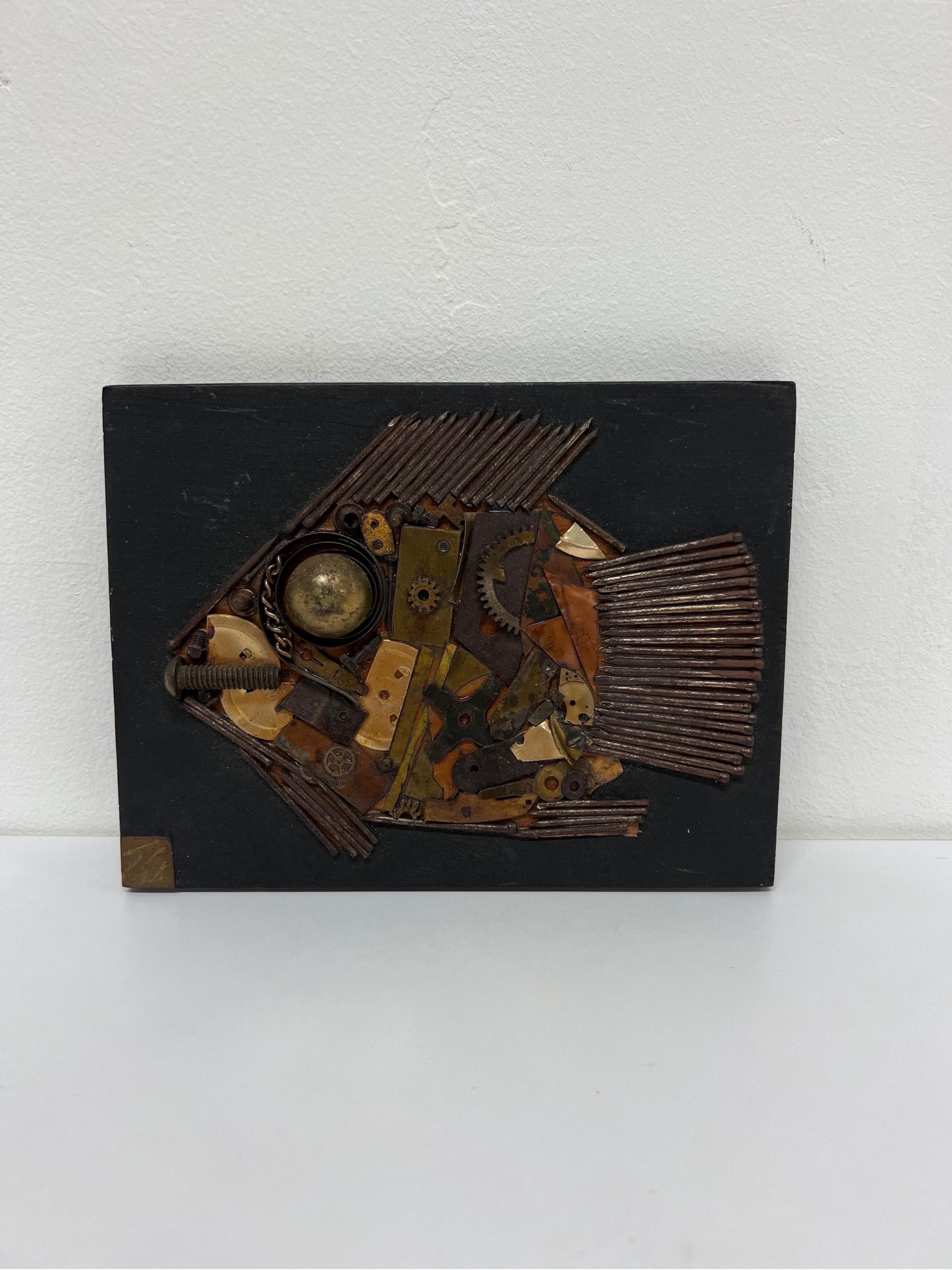 Mid-century modernist abstract fish sculpture by Brazilian artist, Shih Hwa. Assemblage comprised of gears, nails, etc and is mounted to a black wood board. Metal plaque on front with signature. Paper label on back with raisonné.