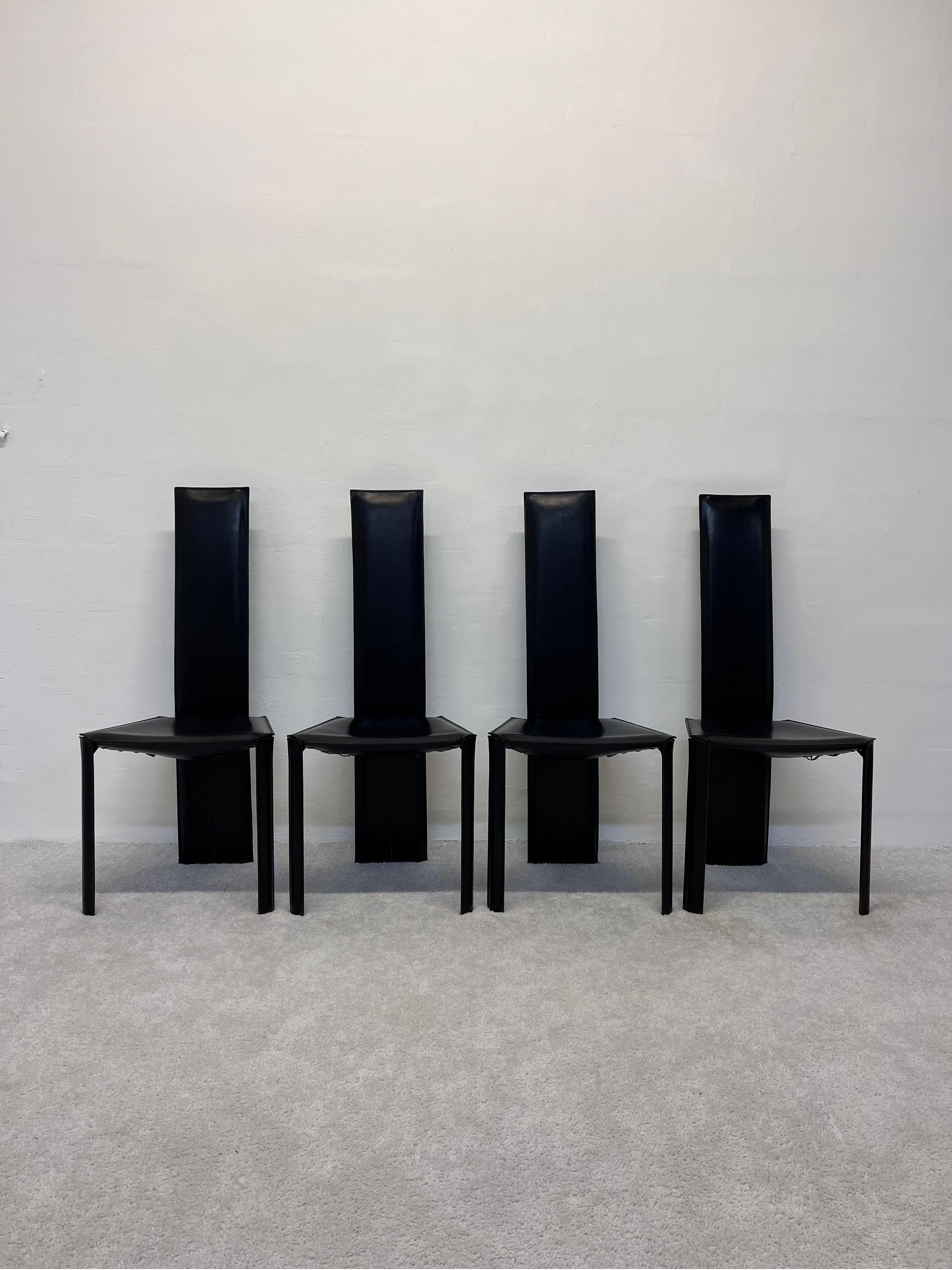 Set of four Brazilian mid-century modern black hand stitched leather dining chairs by De Couro, 1970s.  

We have another set of four in our listing; however, the leather on these has a slight variation with a little more texture.  The other set's
