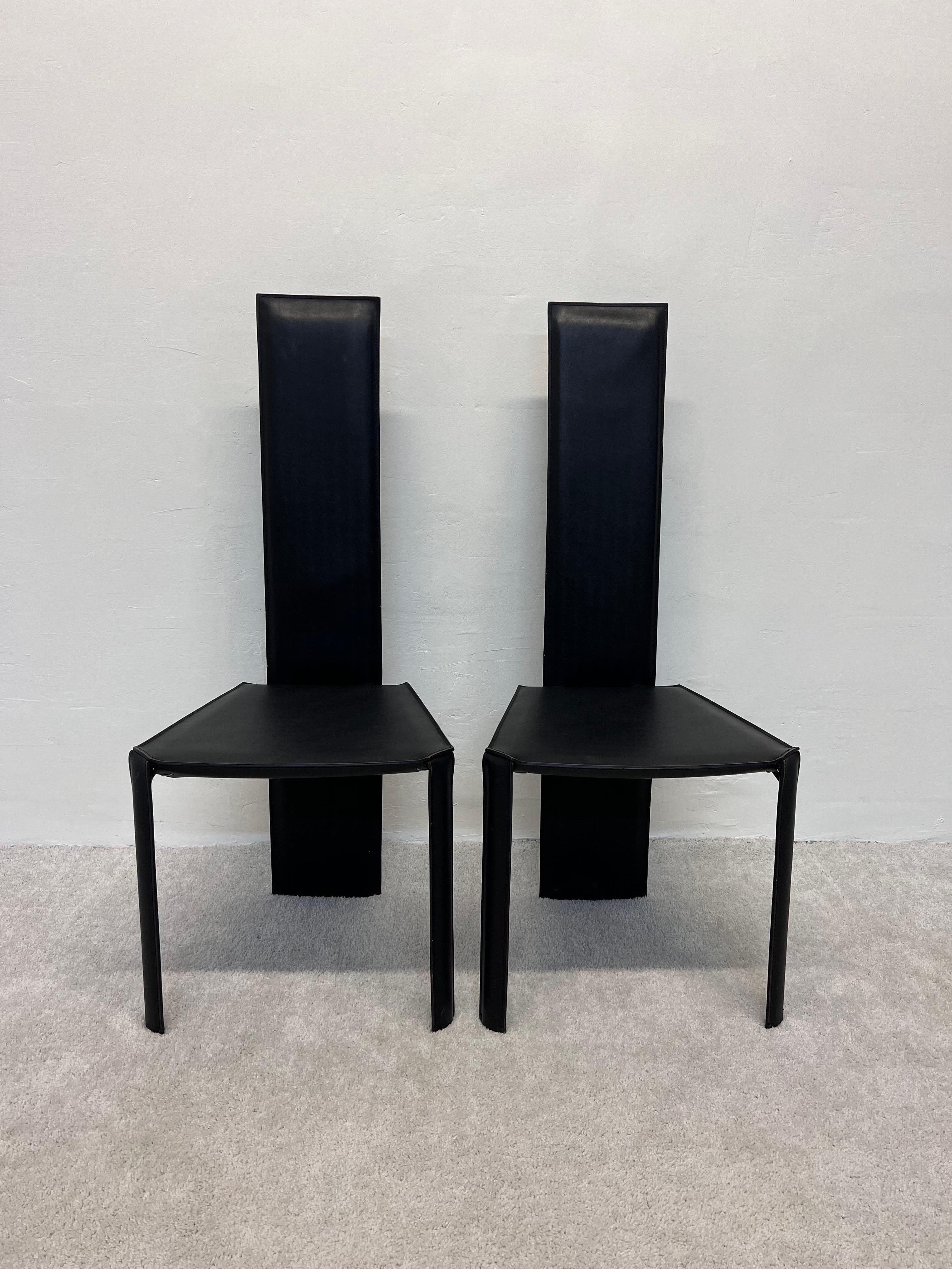Pair of Brazilian postmodern black hand stitched matte black leather dining chairs by Ligne Roset, Brazil 1980s. Both chairs maintain original labels.

 