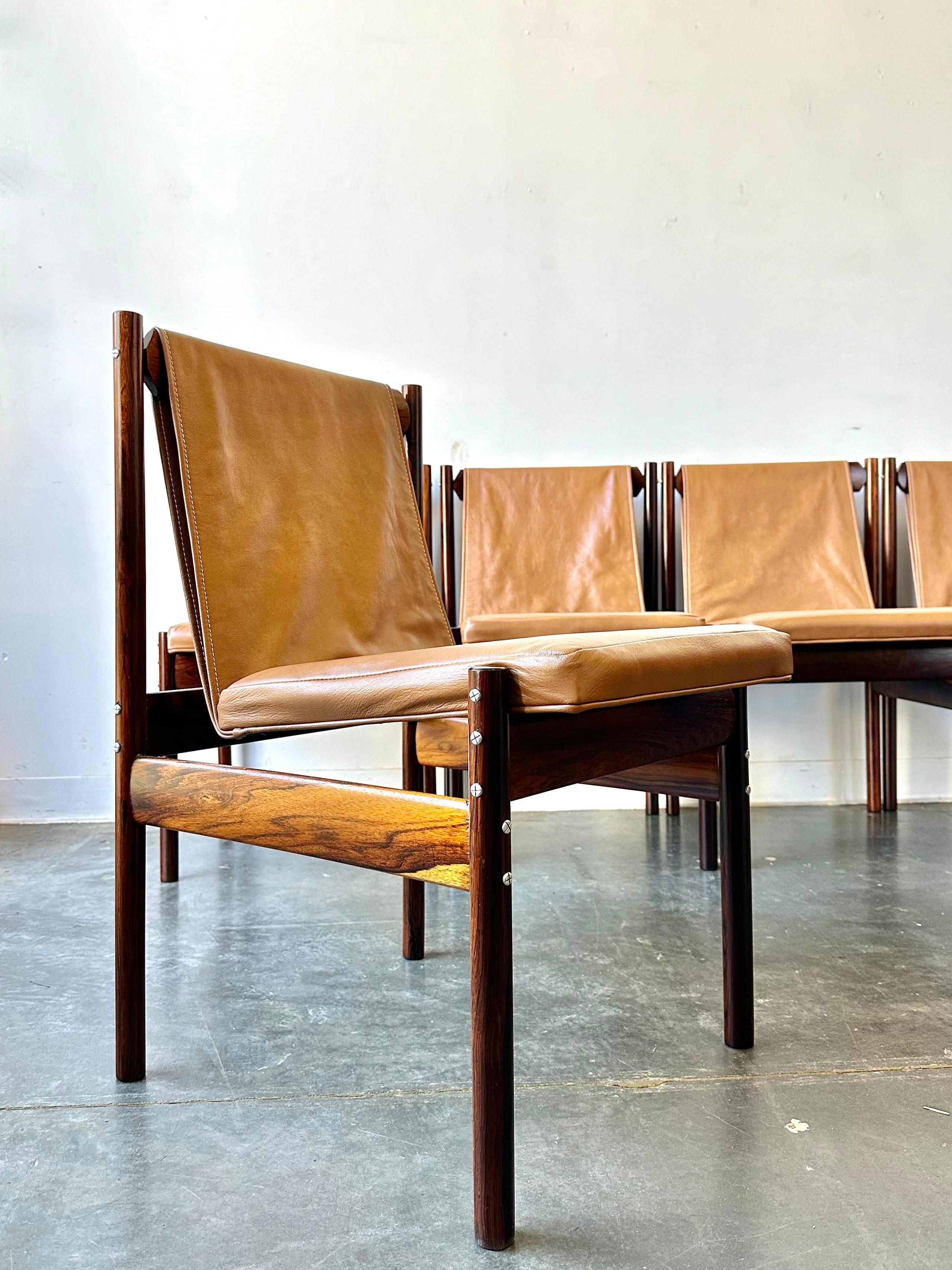 Brazilian rosewood and leather sling dining chairs designed for novo rumo after Jorge Zalsupin circa 1960.

These phenomenal chairs have been professionally restored from frames to brand new Moore and Giles leather.

These are ready to be enjoyed
