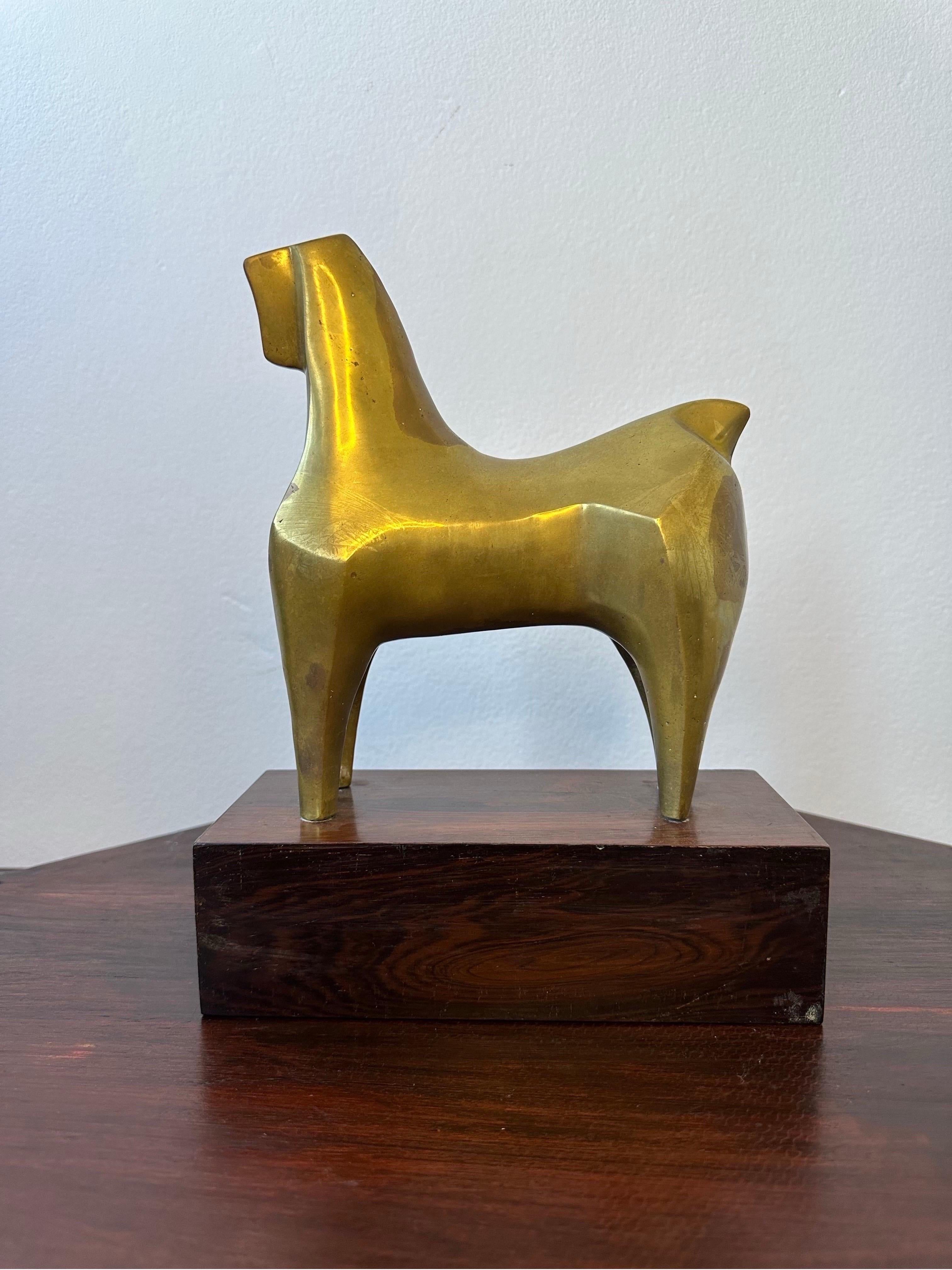 Brazilian modernist bronze horse sculpture standing on a Rosewood base circa 1960s.  The hollow core geometric bronze horse is a testament to the modernist arts movement of Brazil during the 1960s.  The bronze horse stands on beautiful Jacaranda