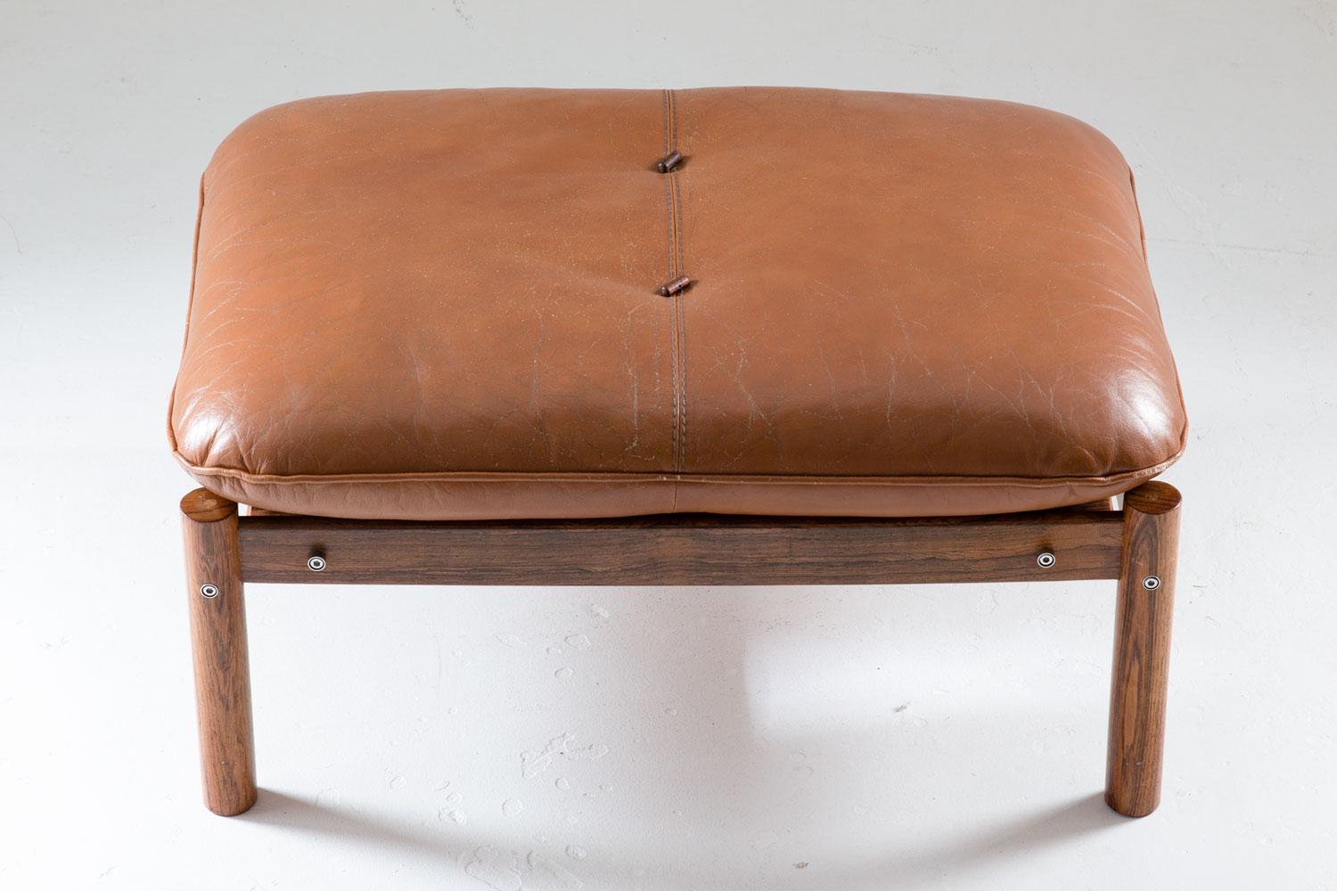 Ottoman / stool by Percival Lafer, Brazil, 1960s.
This ottoman consist of a rosewood frame upon which the cushion rests. The cushions are upholstered in brown leather with rosewood buttons.

   

Condition: The ottoman is in fair original