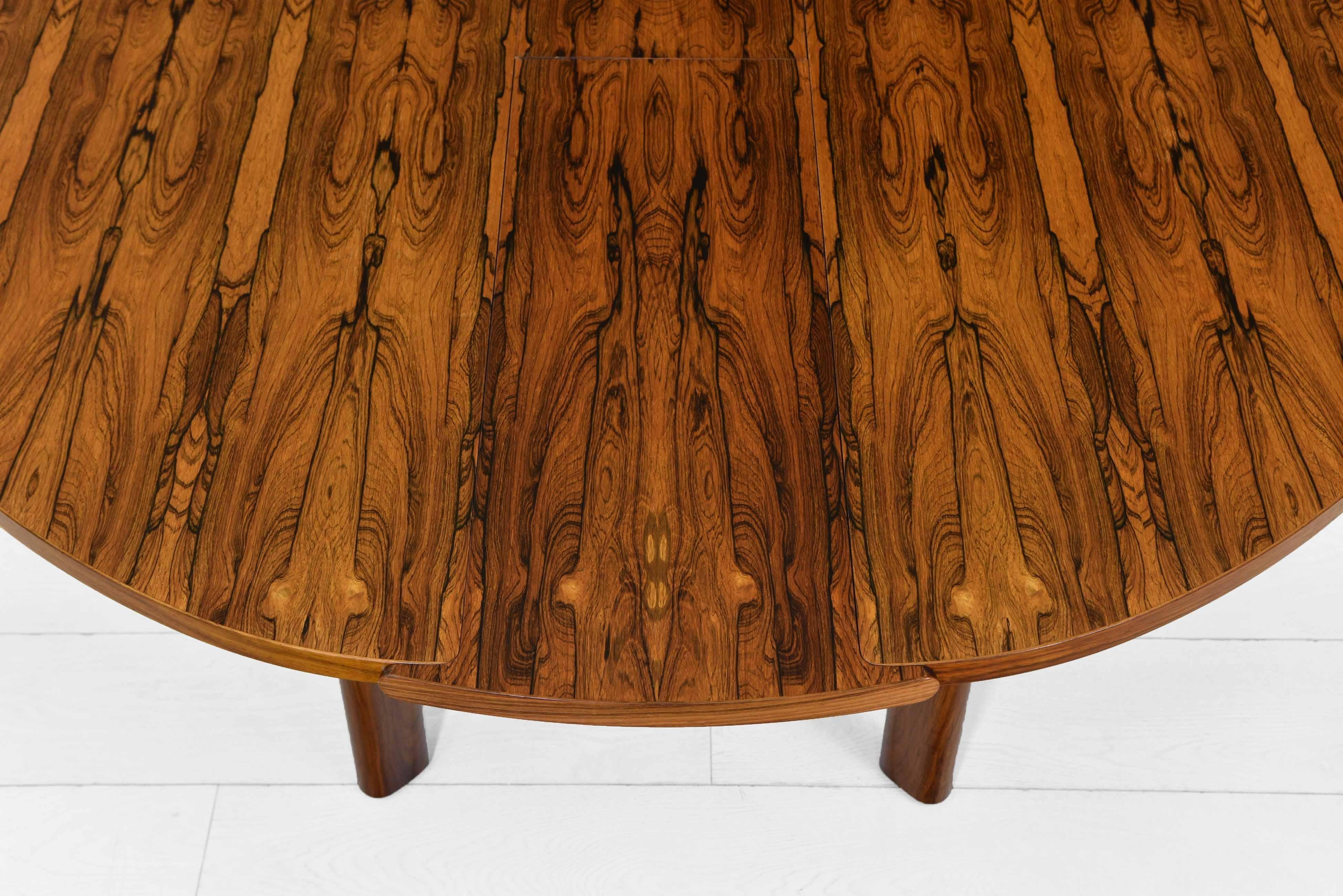 A superb mid century Brazilian rosewood oval dining table. Extends neatly to a circular shape using a very clever method, as shown in the video. English - Circa 1960s.

The table is in very good condition, showing some light signs of use. The