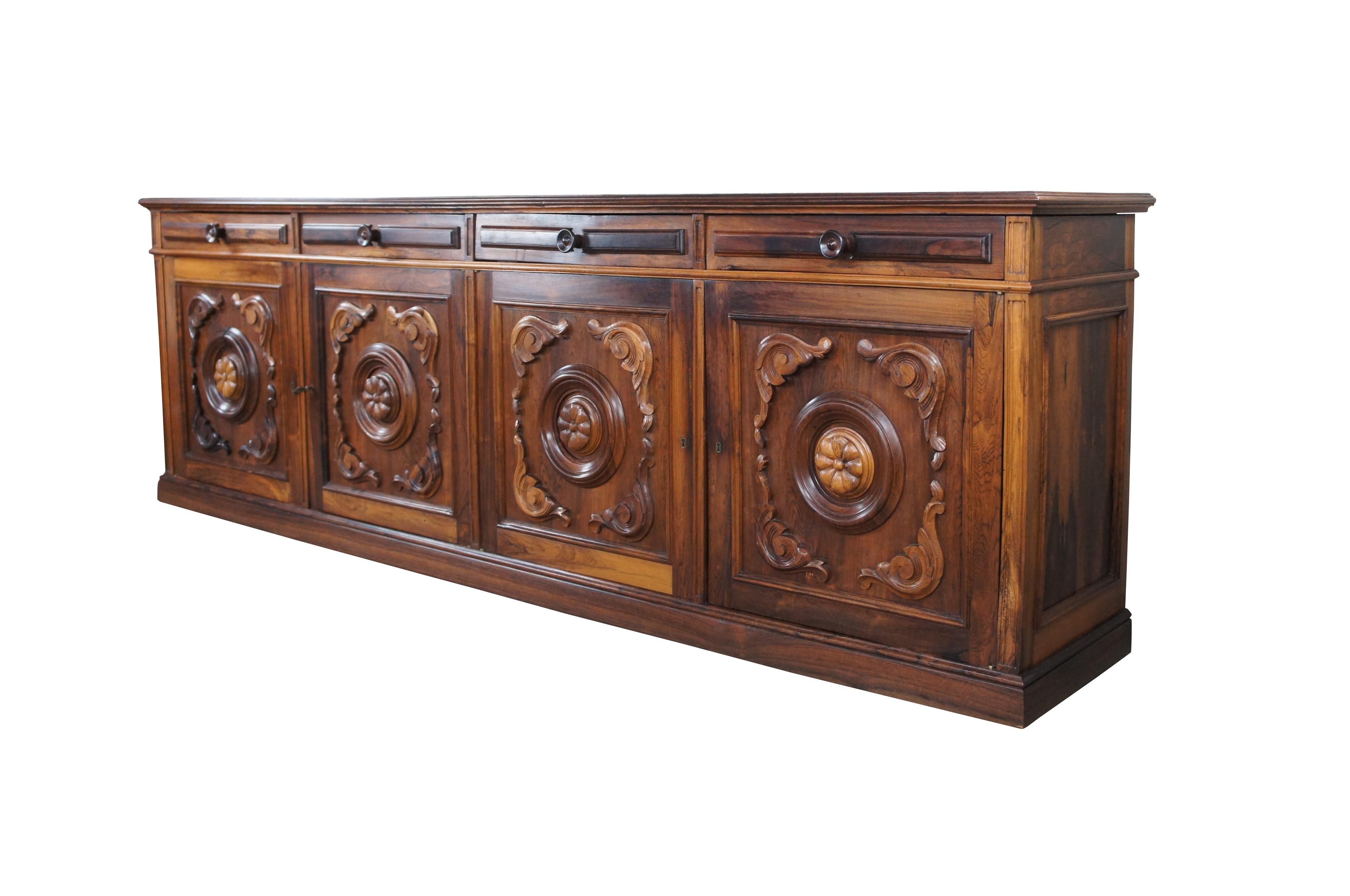 Monumental Brazilian Rosewood (Jacaranda) sideboard, circa 1960s. An impressive case at over eight and a half feet long. Features a mix of French Provincial and Brittany styling. Includes four large dovetailed drawers over two lower cabinets with