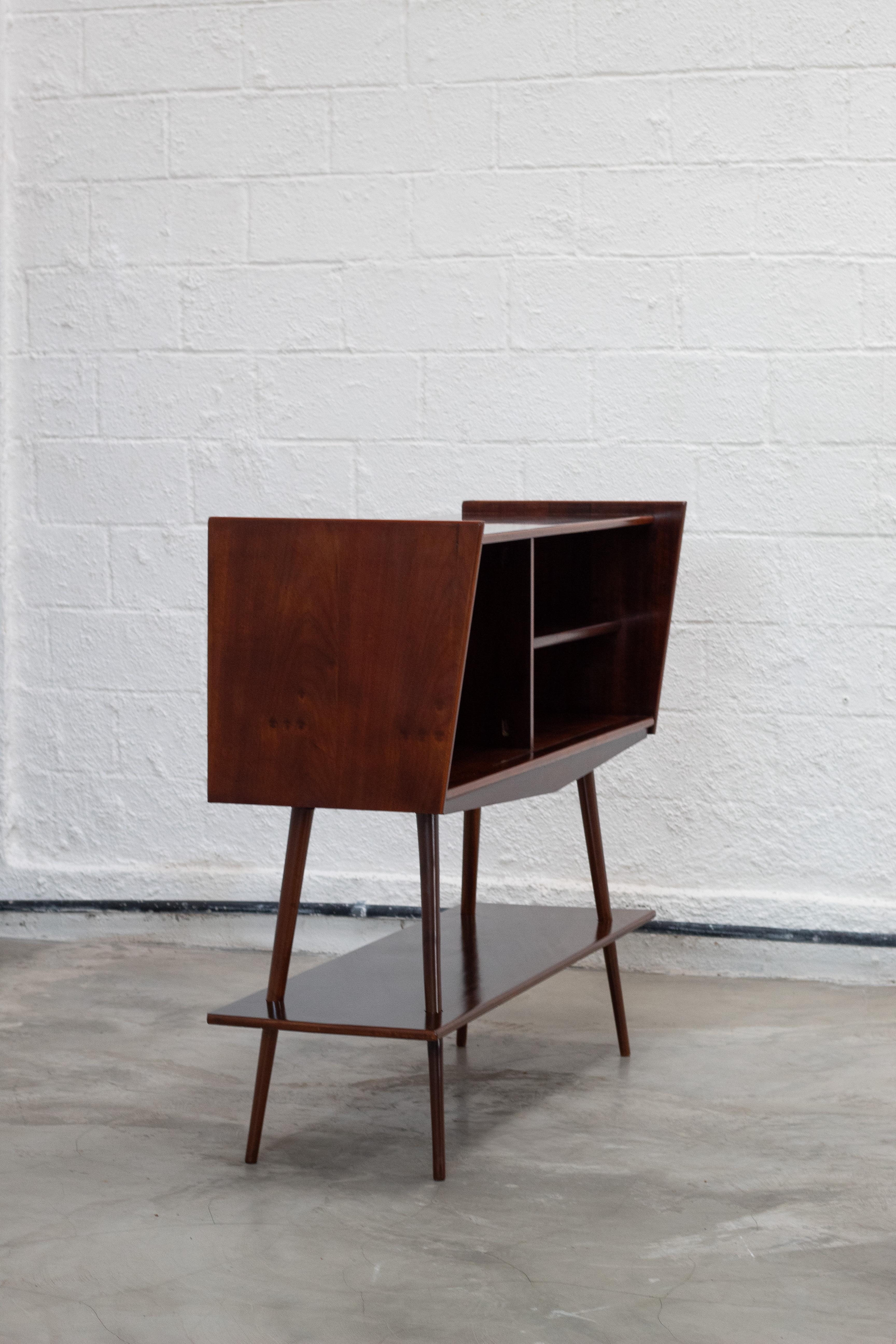    Sculptural sideboard by Móveis Cimo, circa 1960, crafted in solid and veneered imbuia wood. The piece showcases clean lines and elegant proportions, characteristic of Brazilian Mid-Century Modern design, highlighted by its tapered legs and