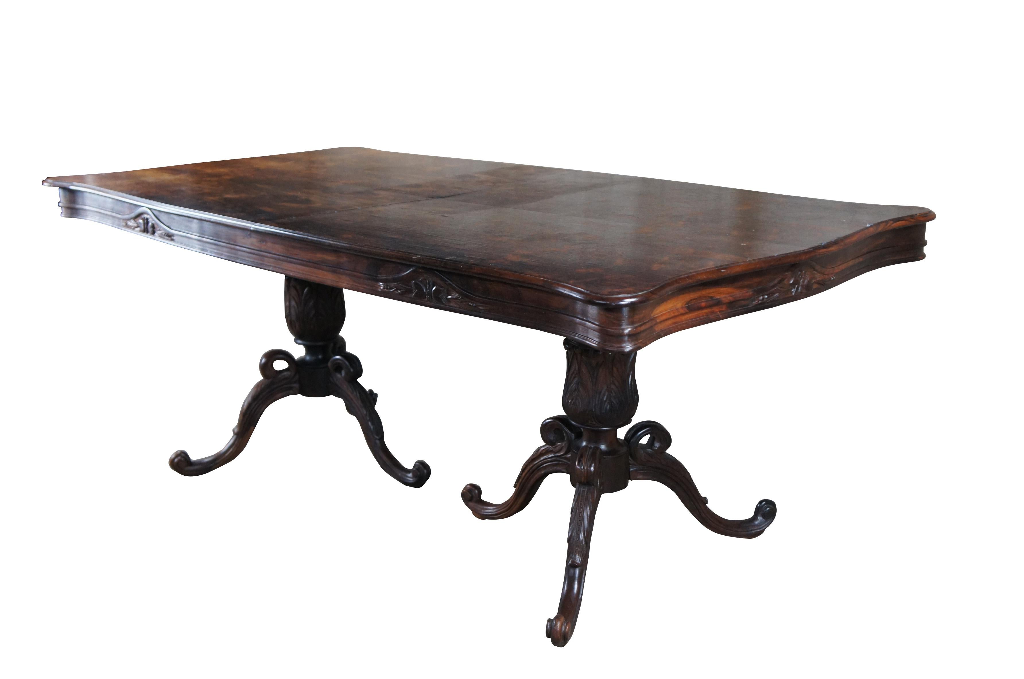 Mid century Brazilian Rosewood (Jacaranda) dining table, circa 1960s. Features rectangular serpentine form with double pedestal tri foot base, carved acanthus and floral motif and one extendable leaf.


Dimensions:
39