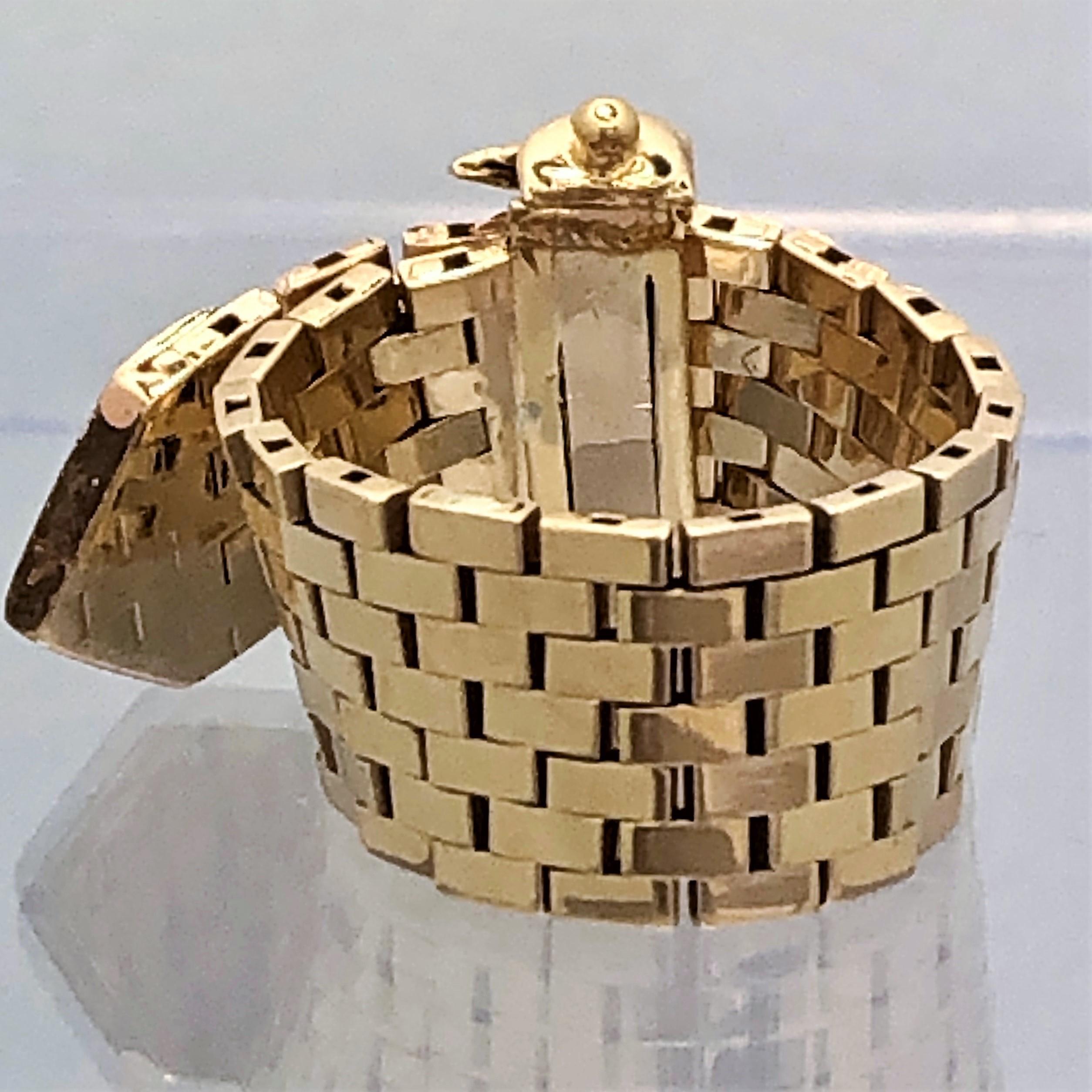 Made of 14K Yellow Gold, this Mid-Century brick style buckle ring is set with nineteen 
round brilliant cut diamonds weighing an approximate total of .15CT of overall F/G Color 
and VS2 Clarity. Measures just under 3 inches long (2 15/16 inches) by