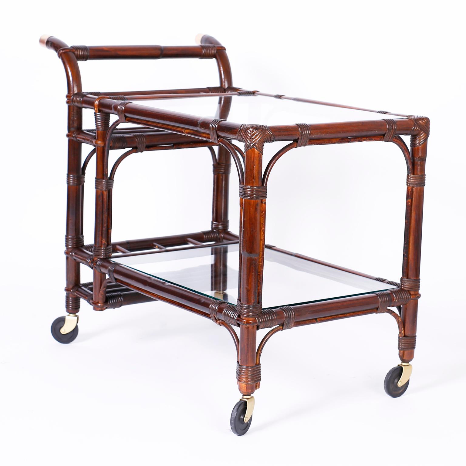 Midcentury bar cart or tea cart with a bamboo frame wrapped with reed.