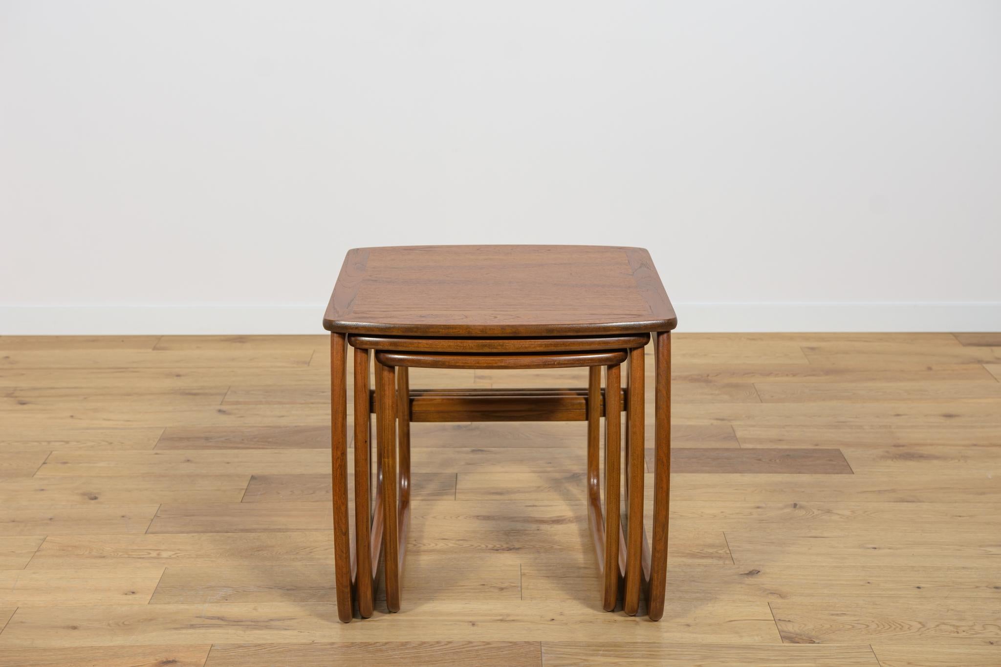 A set of three teak coffee tables manufactured in the 1960s in Great Britain. The tables have interesting geometric shapes. The whole thing has been completely renovated, the wood has been cleaned of the old surface, stained with an oak-colored