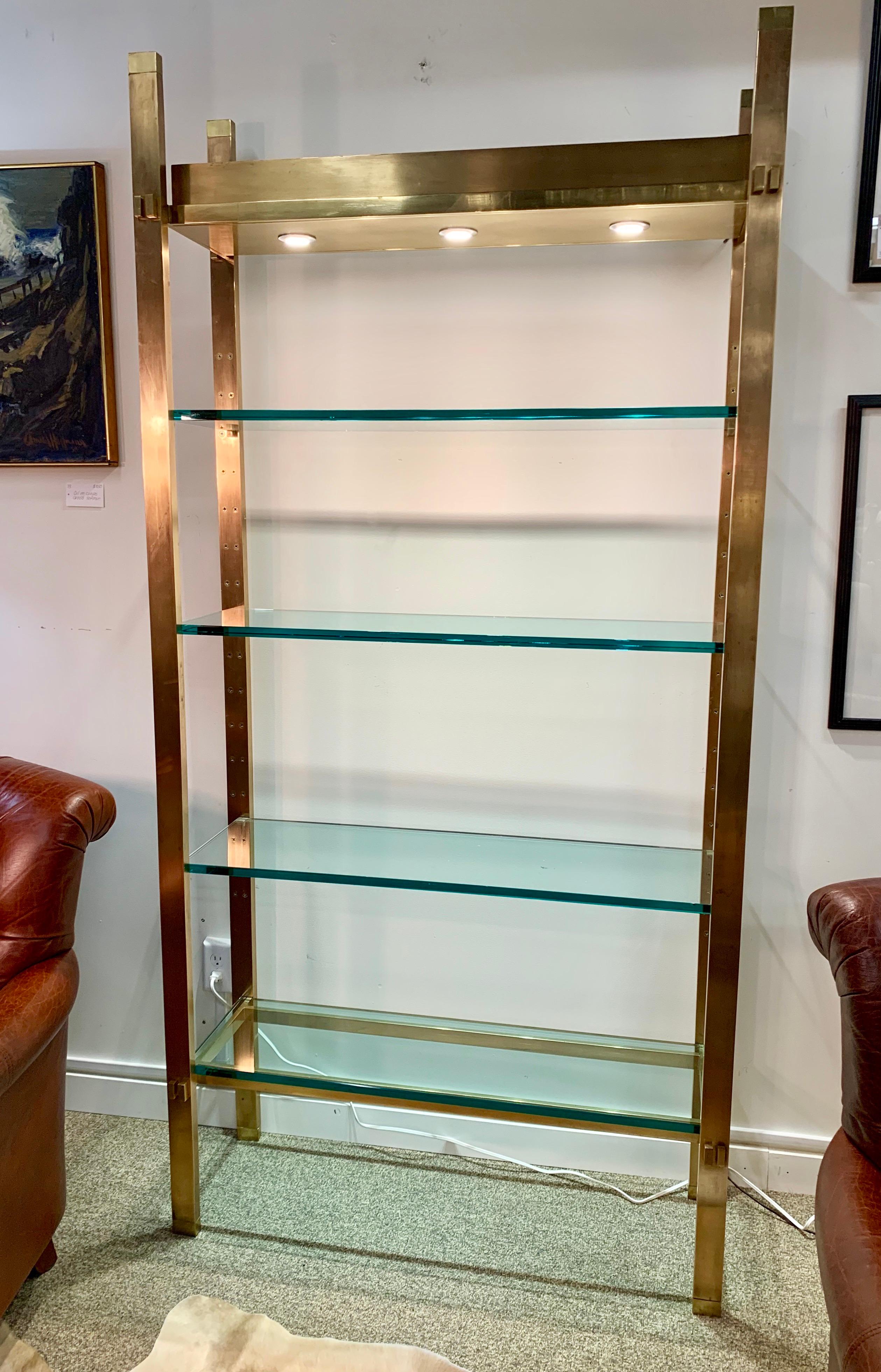 Paul M. Jones designed polished bronze and glass four tiered illuminated étagère or display shelf with 3/4” thick glass shelves.