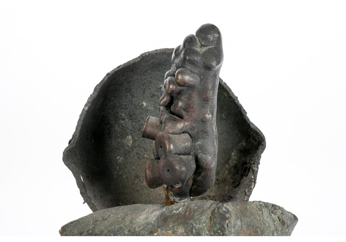 Unique Bronze in a truly Brutalist/ organic style treatment with a fine, raw surface patina having some of the investment from the casting process left on the surfaces. By multi-disciplinary American Artist Norma Flanagan. A textured patinated