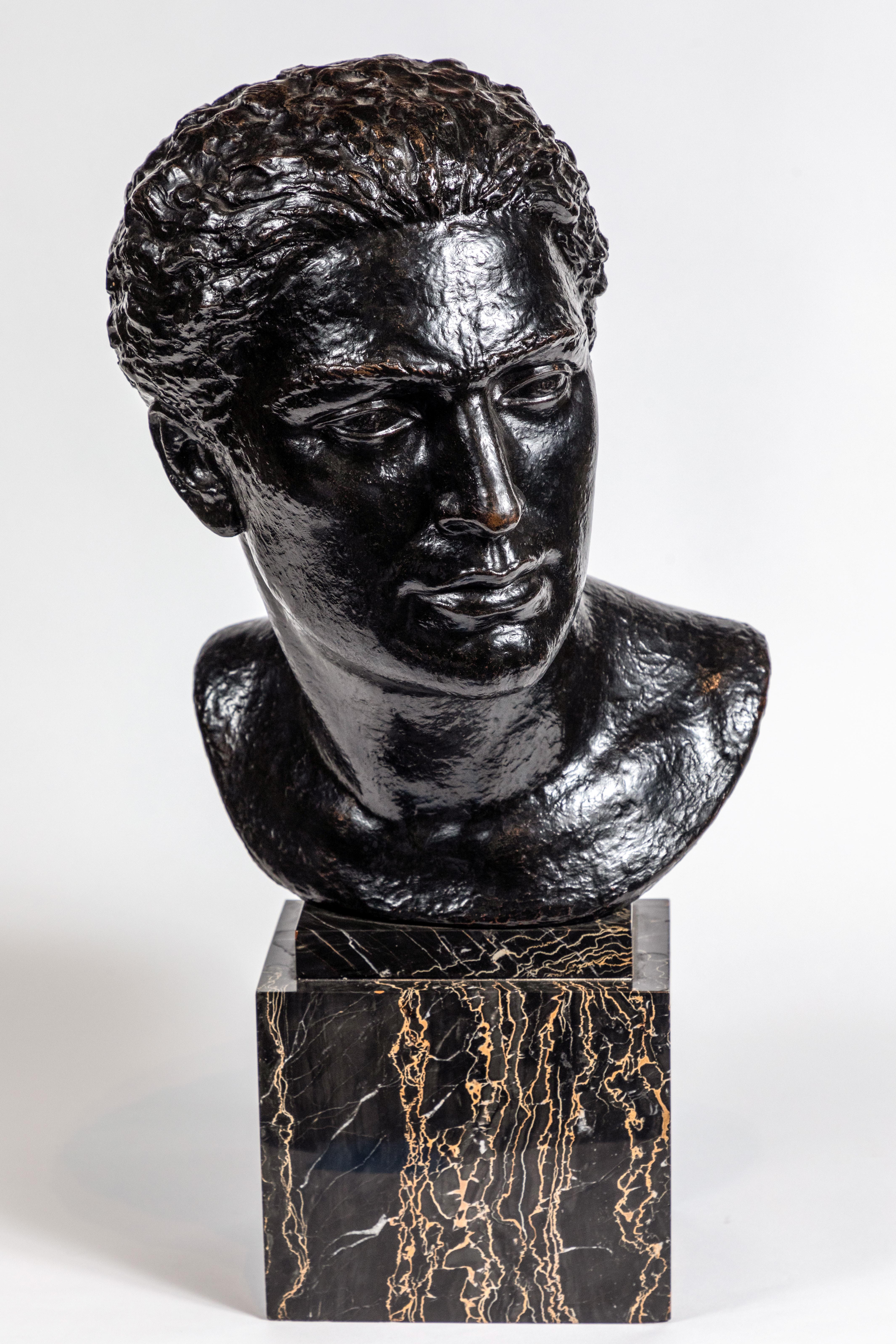 Large, midcentury, cast bronze bust of a man mounted on a chic, veined, polished marble base of the same period.