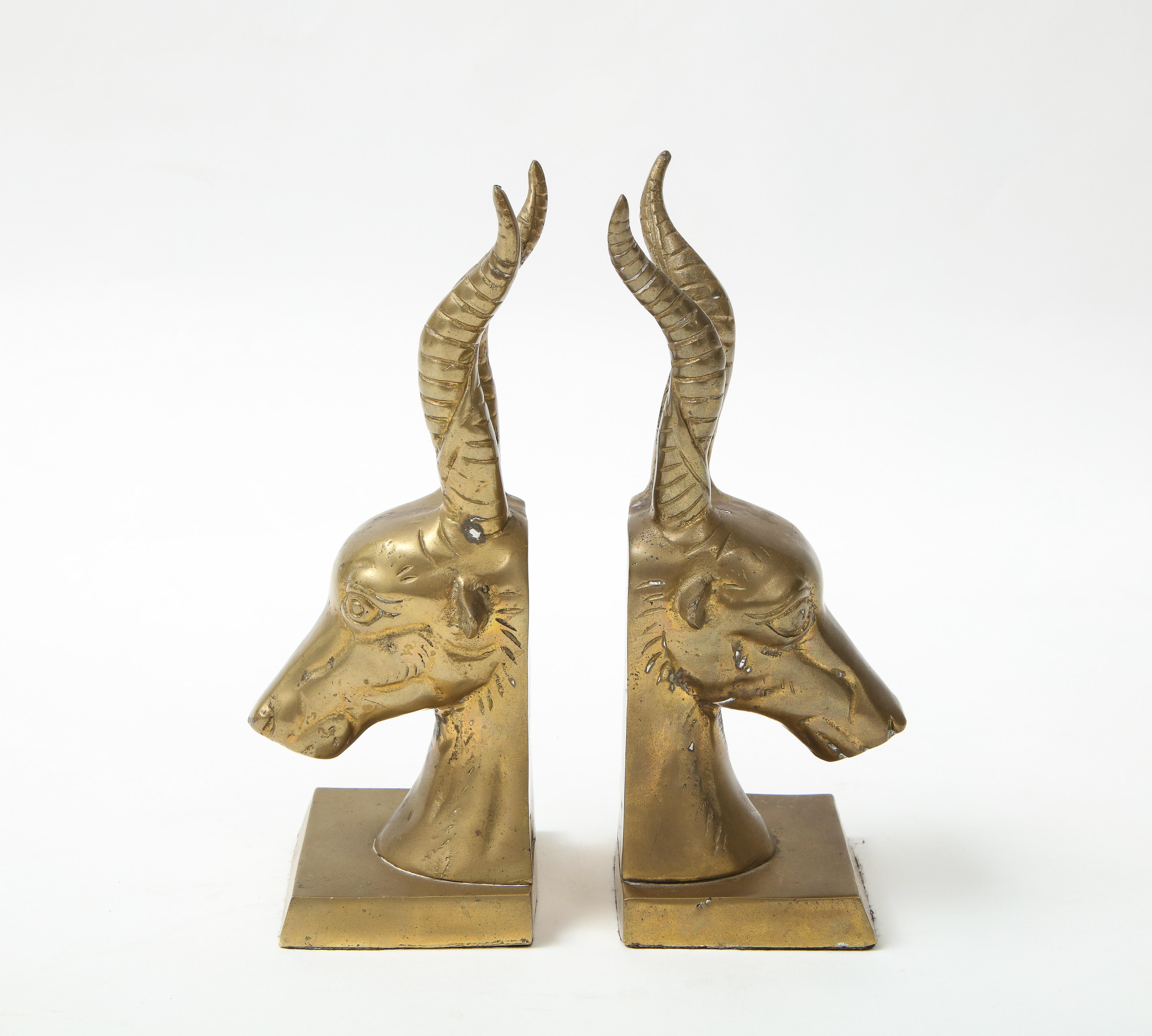 Mid century pair of cast bronze stylized goat bookends, felt protectors on bottoms.