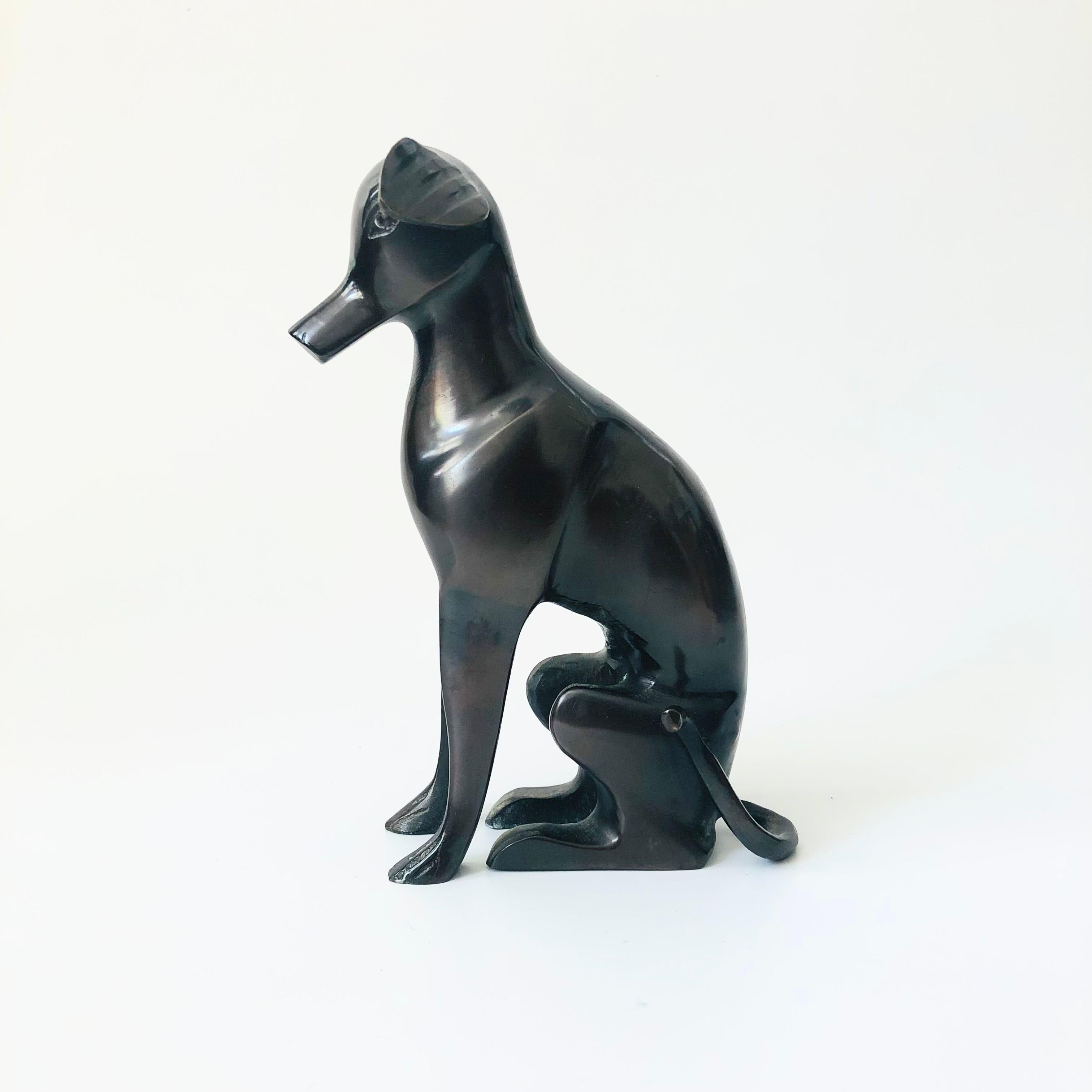 A vintage mid century bronze greyhound statue. Great mid century stylized design, dark coloring to the bronze. Made in Italy sticker attache to the base.

